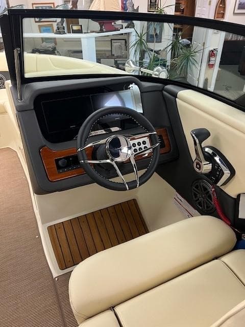 Interior of 2025 Chris-Craft Sportster 25 boat with modern dashboard and steering wheel.