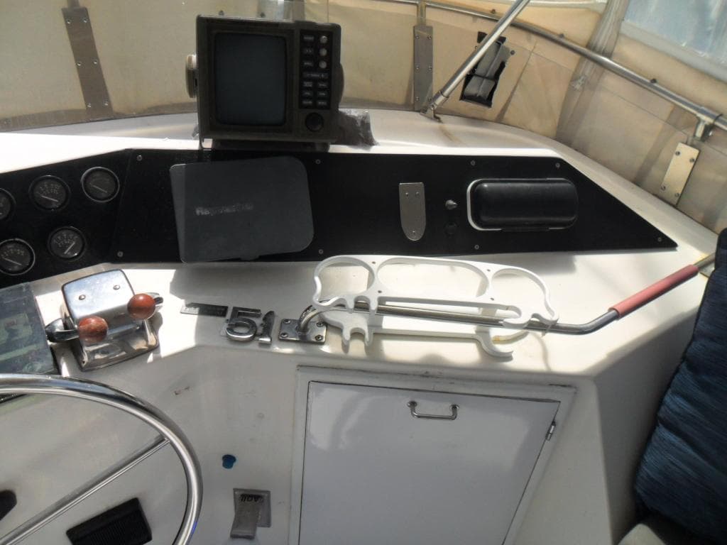 1986 Symbol Yachtfisher helm with navigation equipment and controls.