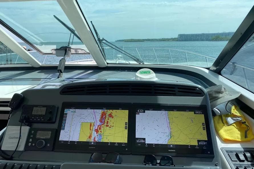 Cockpit view of 2004 Tiara Yachts 4400 Sovran with navigation screens and open water ahead.