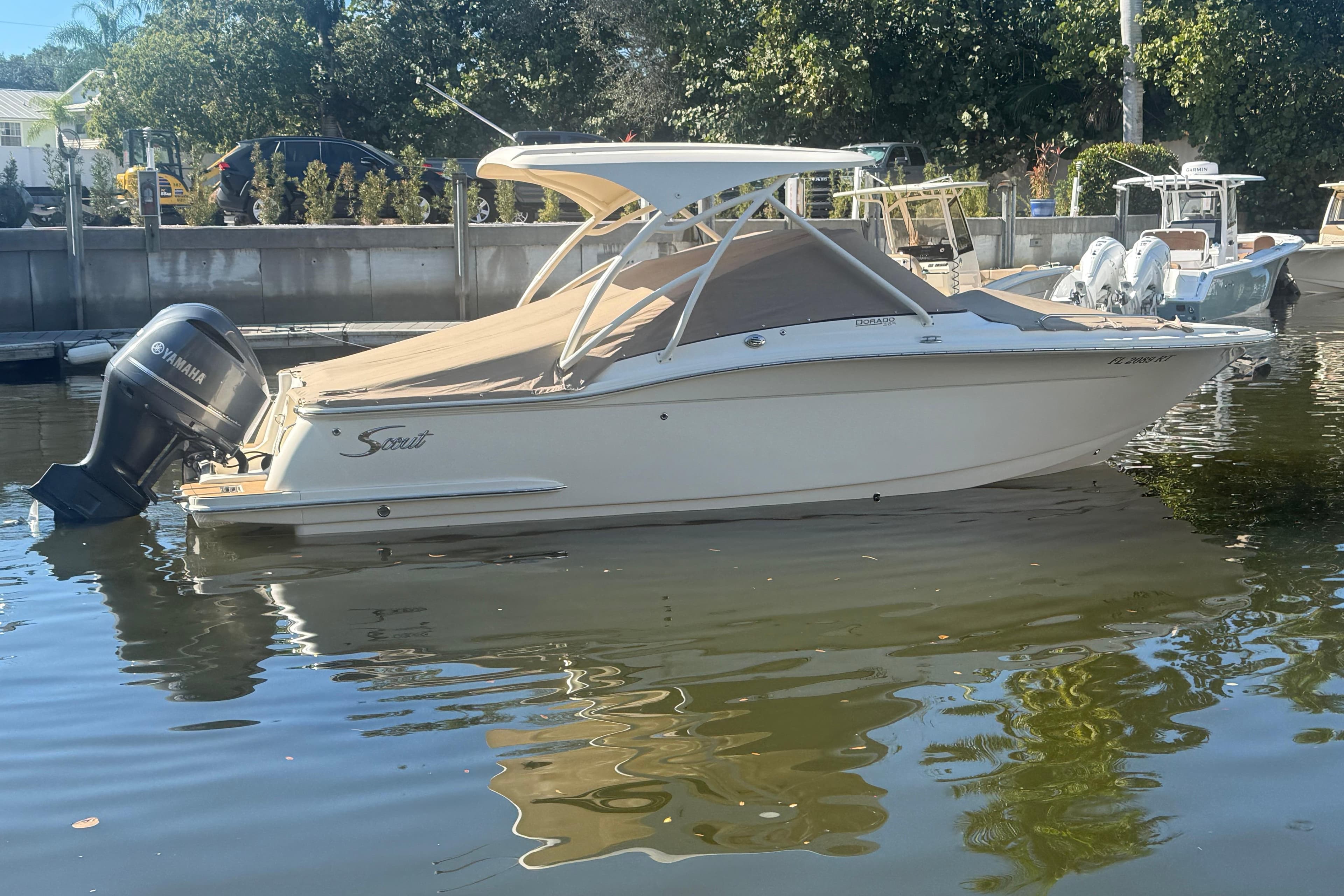 2019 Scout 255 Dorado boat with Yamaha engine docked in calm waters.