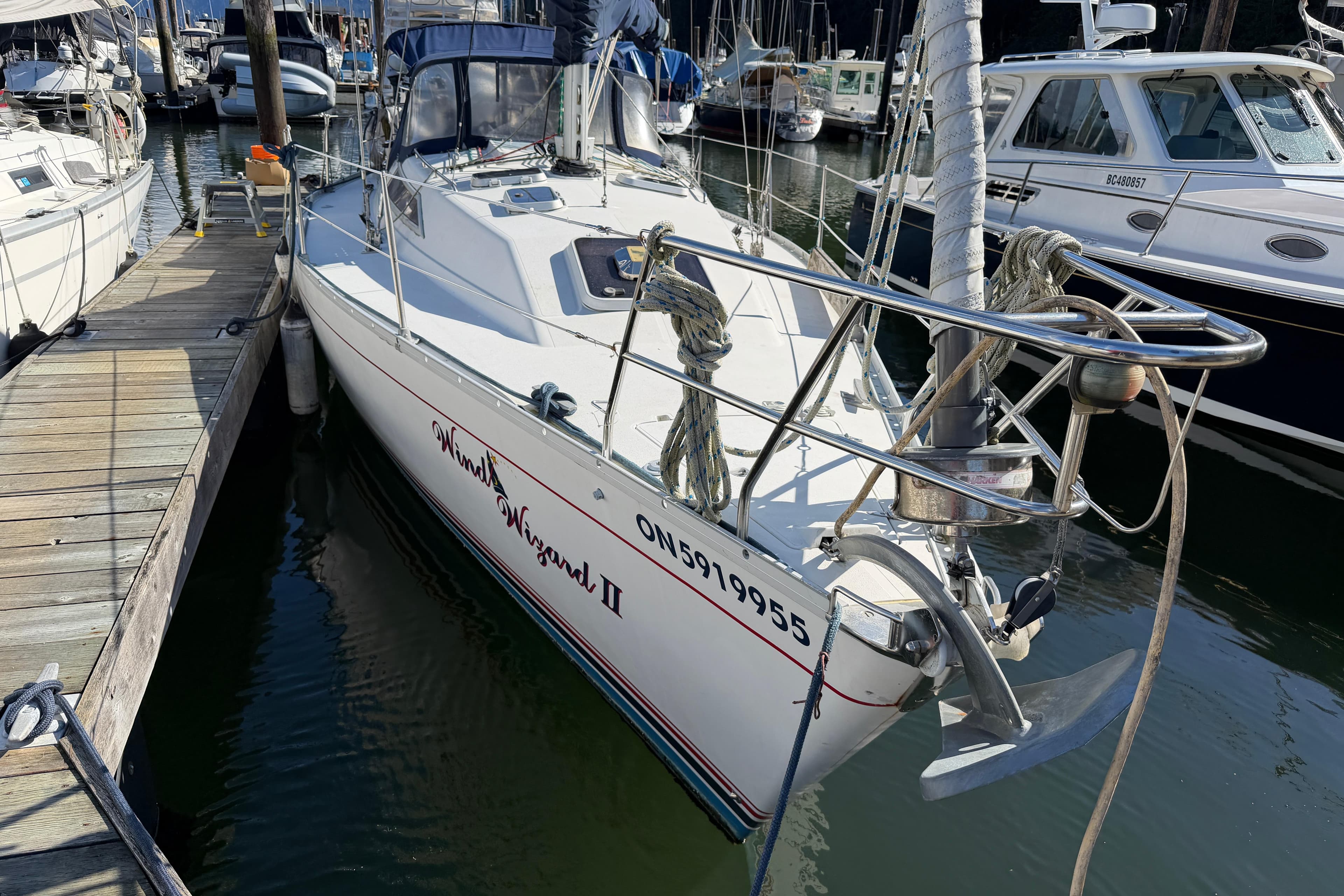 1988 CS 36 Merlin sailboat docked at marina, featuring sleek design and visible anchor.