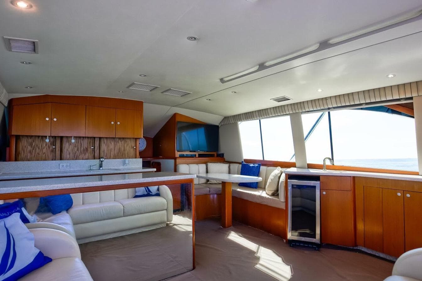 Luxurious interior of 1999 Ocean Yachts 48 Super Sport with modern furnishings and ocean view.
