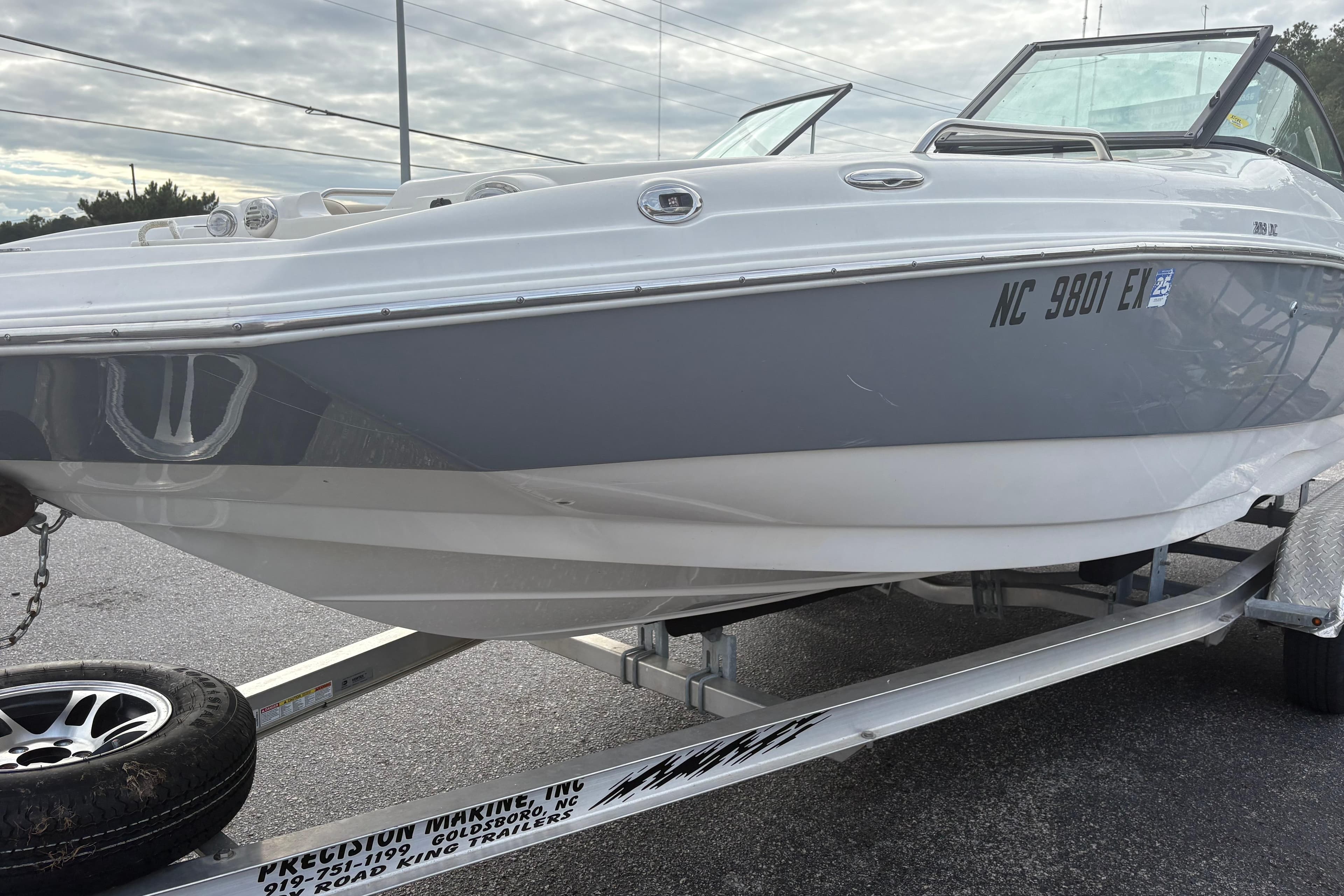 2022 NauticStar 203 DC boat on trailer, gray and white exterior, parked outdoors.