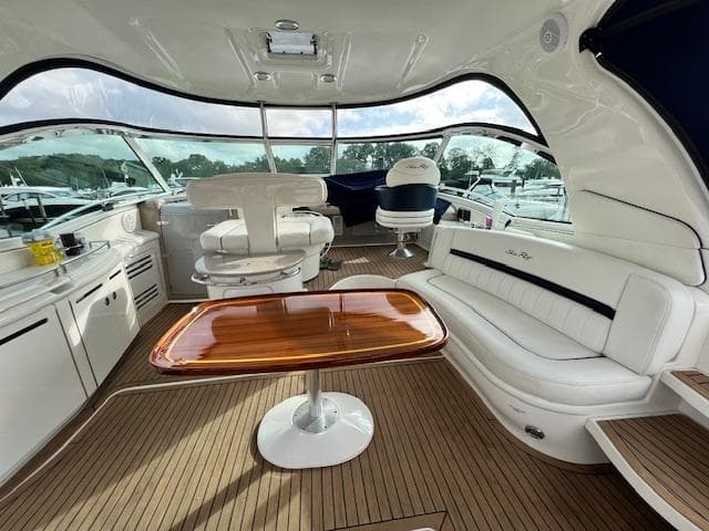 Luxurious 2005 Sea Ray 500 Sundancer yacht interior with elegant seating and wooden table.