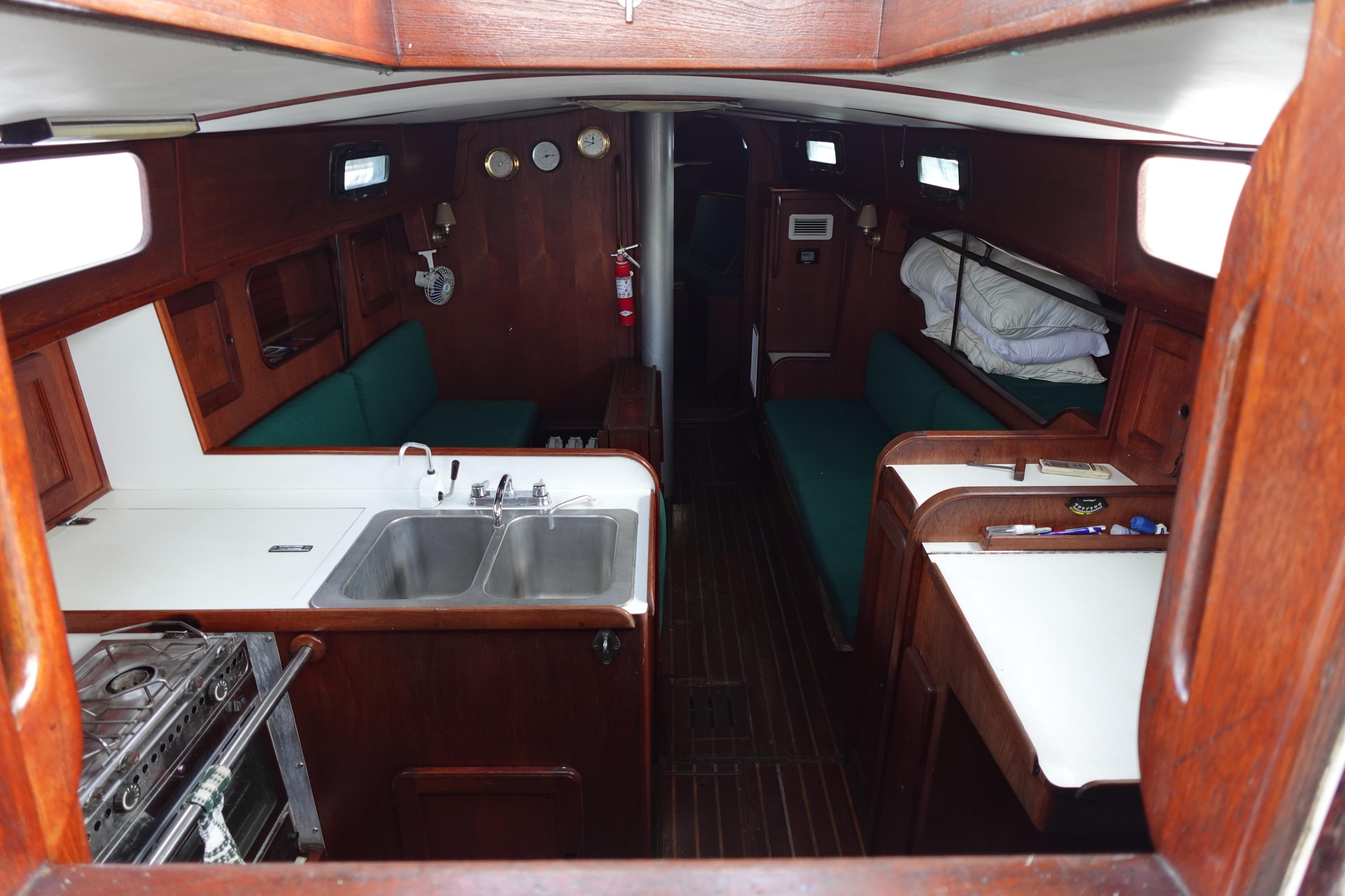 Interior of 1982 Morgan 383 sailboat with kitchen, seating, and wooden finishes.