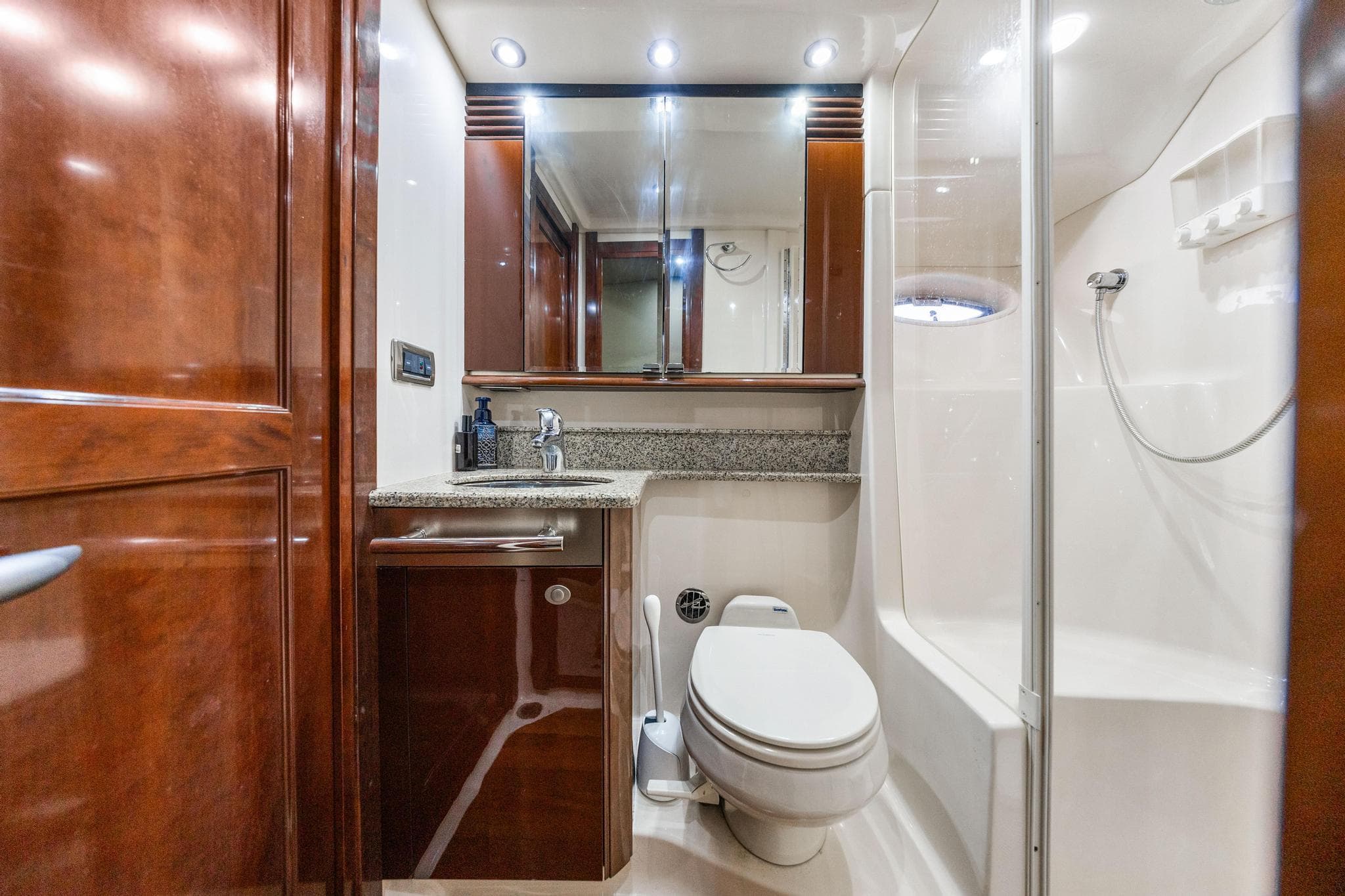 Luxurious bathroom in 2007 Sea Ray 52 Sedan Bridge yacht with wood cabinetry and modern fixtures.