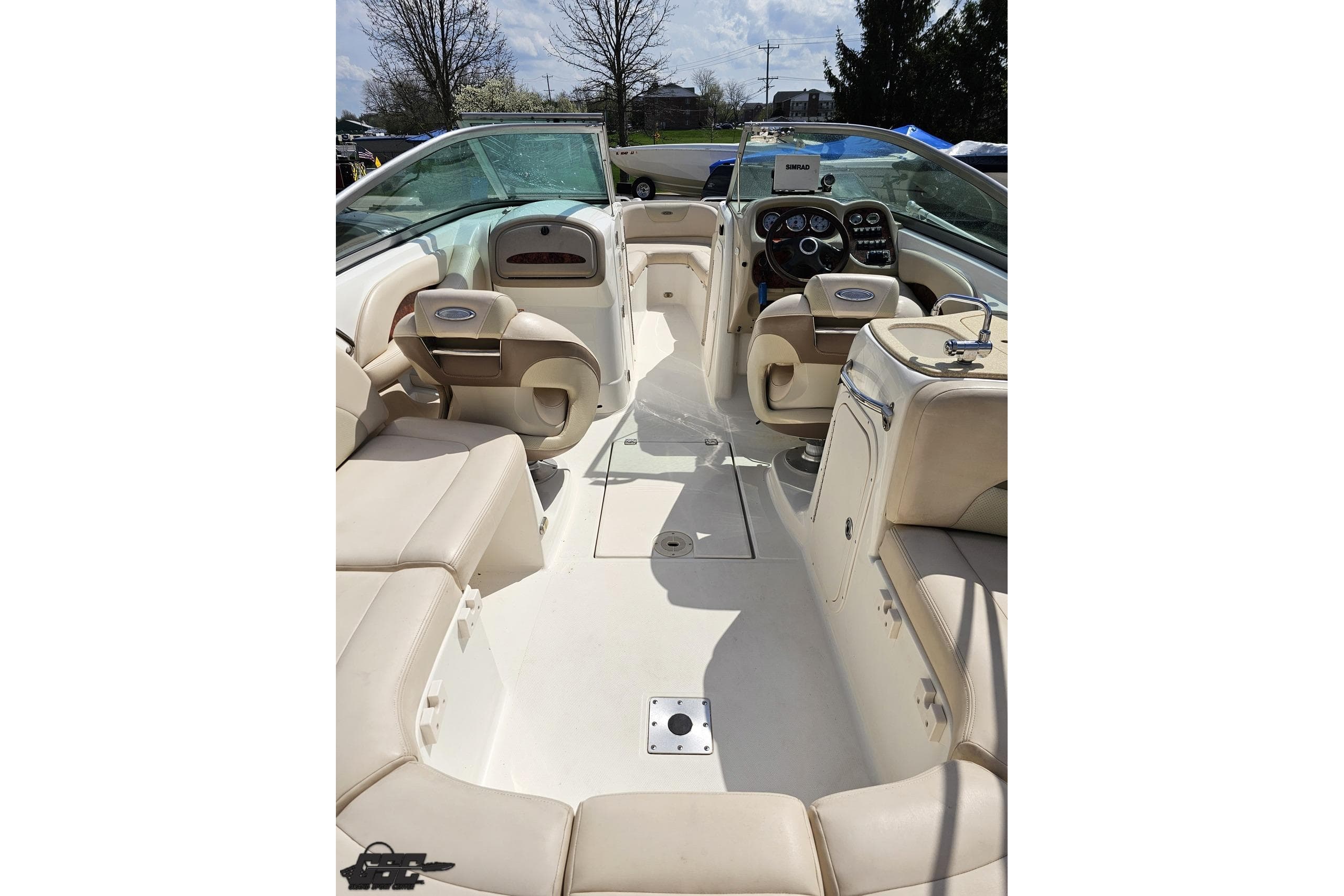 2007 Chaparral 256 SSi boat interior with beige seating and modern dashboard controls.