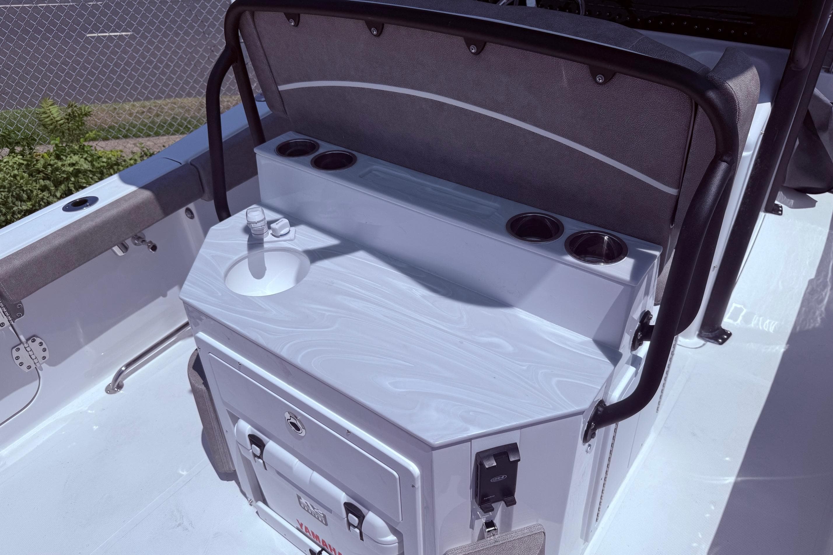 2026 Sea Hunt Ultra 265 SE boat interior with sink and cup holders.