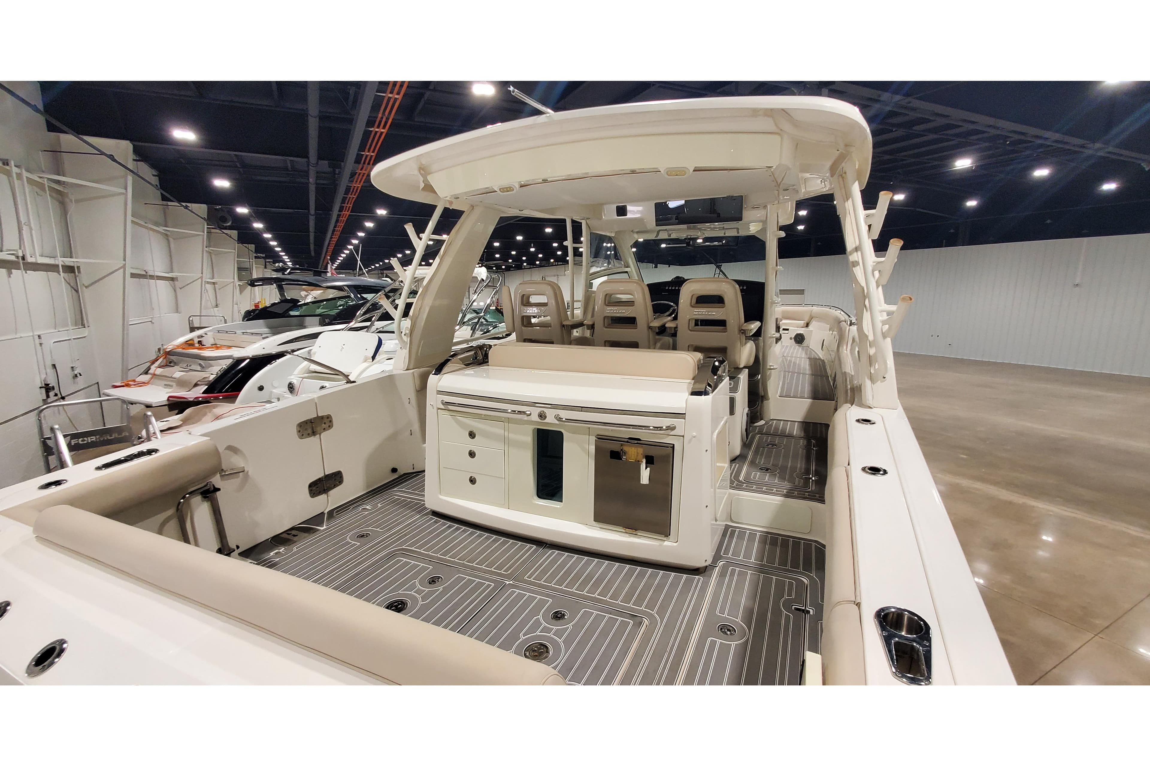 2016 Boston Whaler 420 Outrage boat interior with seating and storage, displayed indoors.