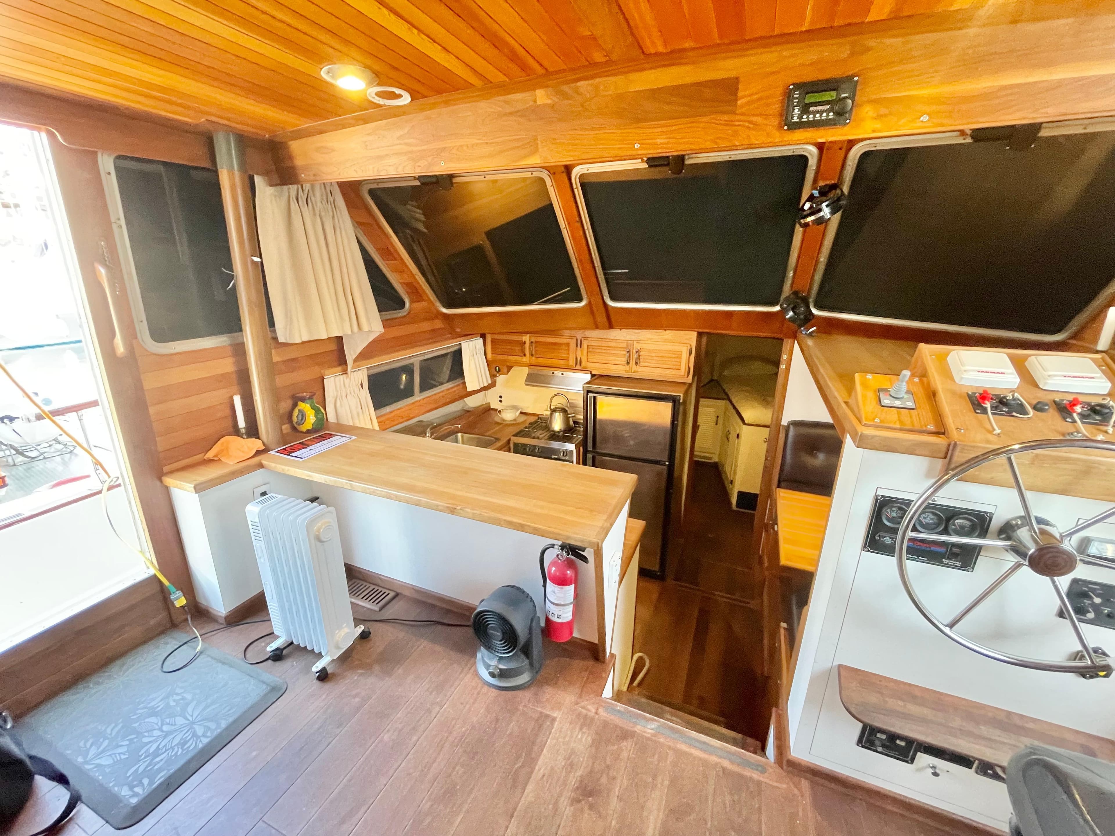 1976 Tollycraft 48 Cockpit Motor Yacht interior with wood paneling and helm station.
