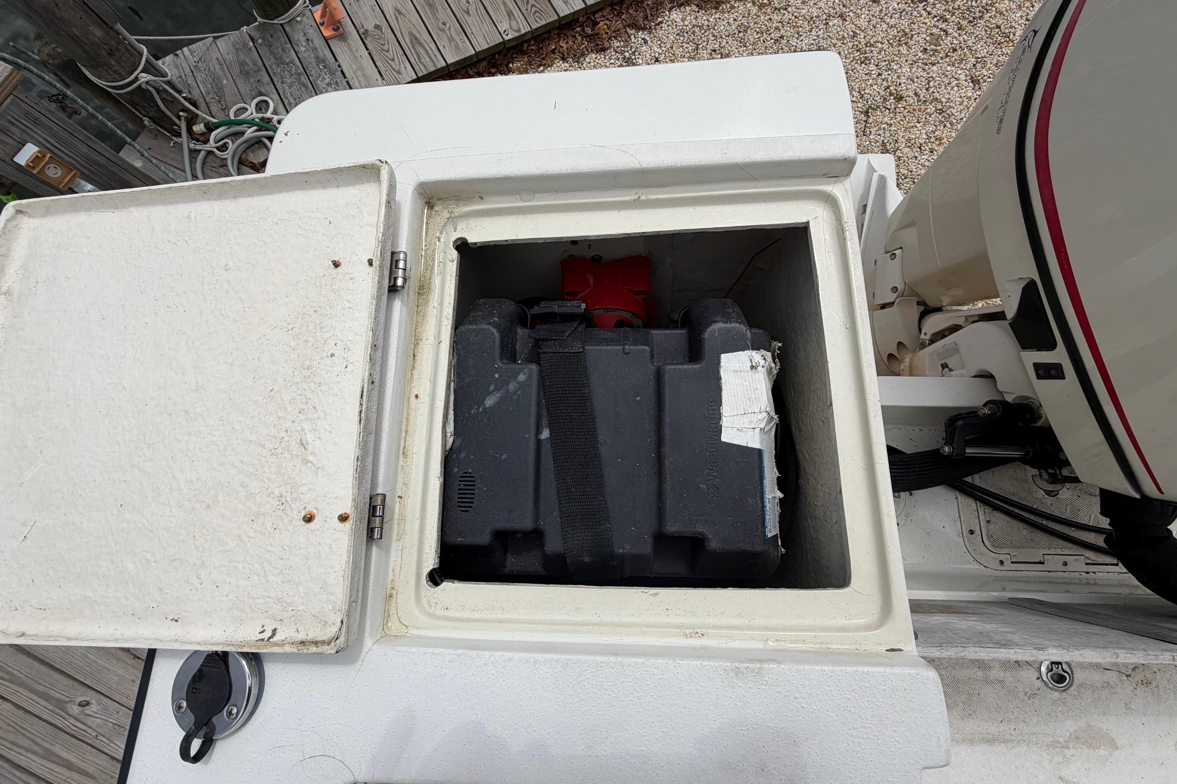 Battery compartment of a 1985 SeaCraft SC 23 Classic boat, open for inspection.