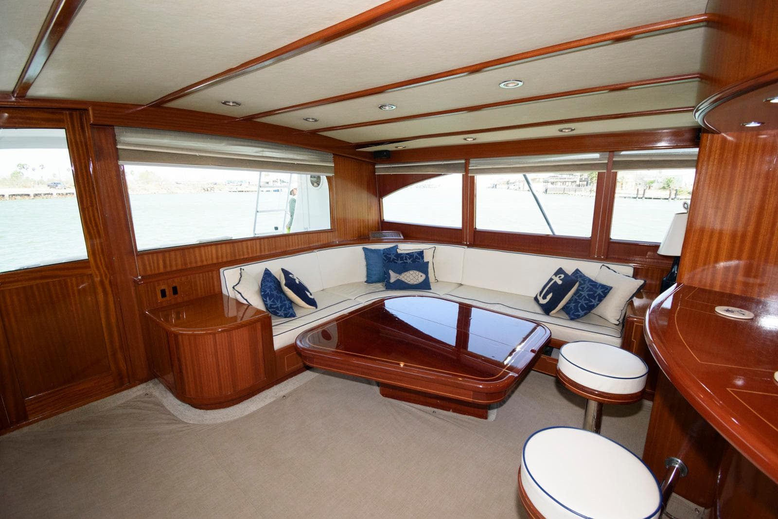 Luxurious interior of 1998 Huckins 70 Sportfish Convertible yacht with elegant wood finish.