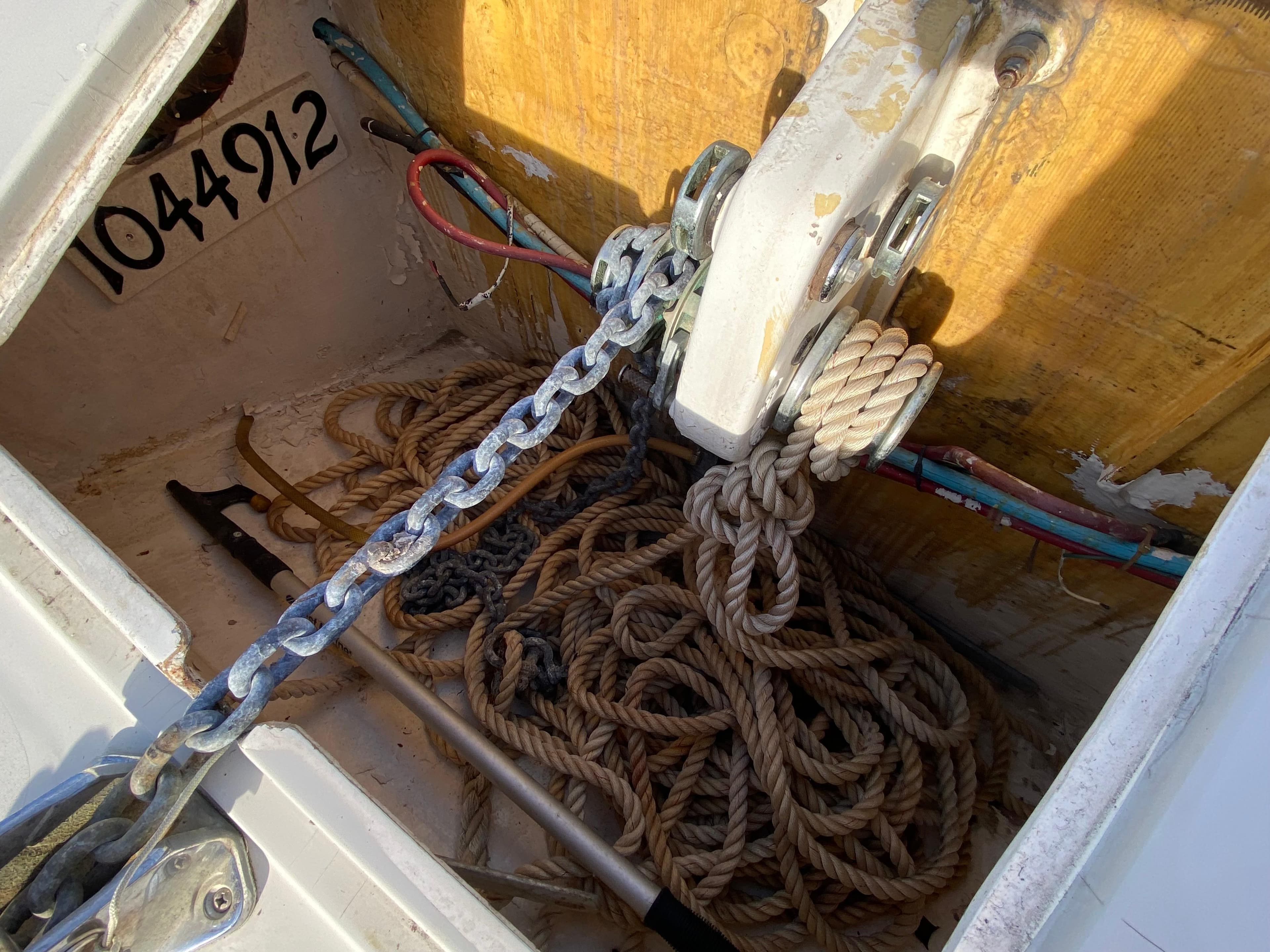 Anchor locker of 1995 Mares 58 Power Cat with ropes and chain.