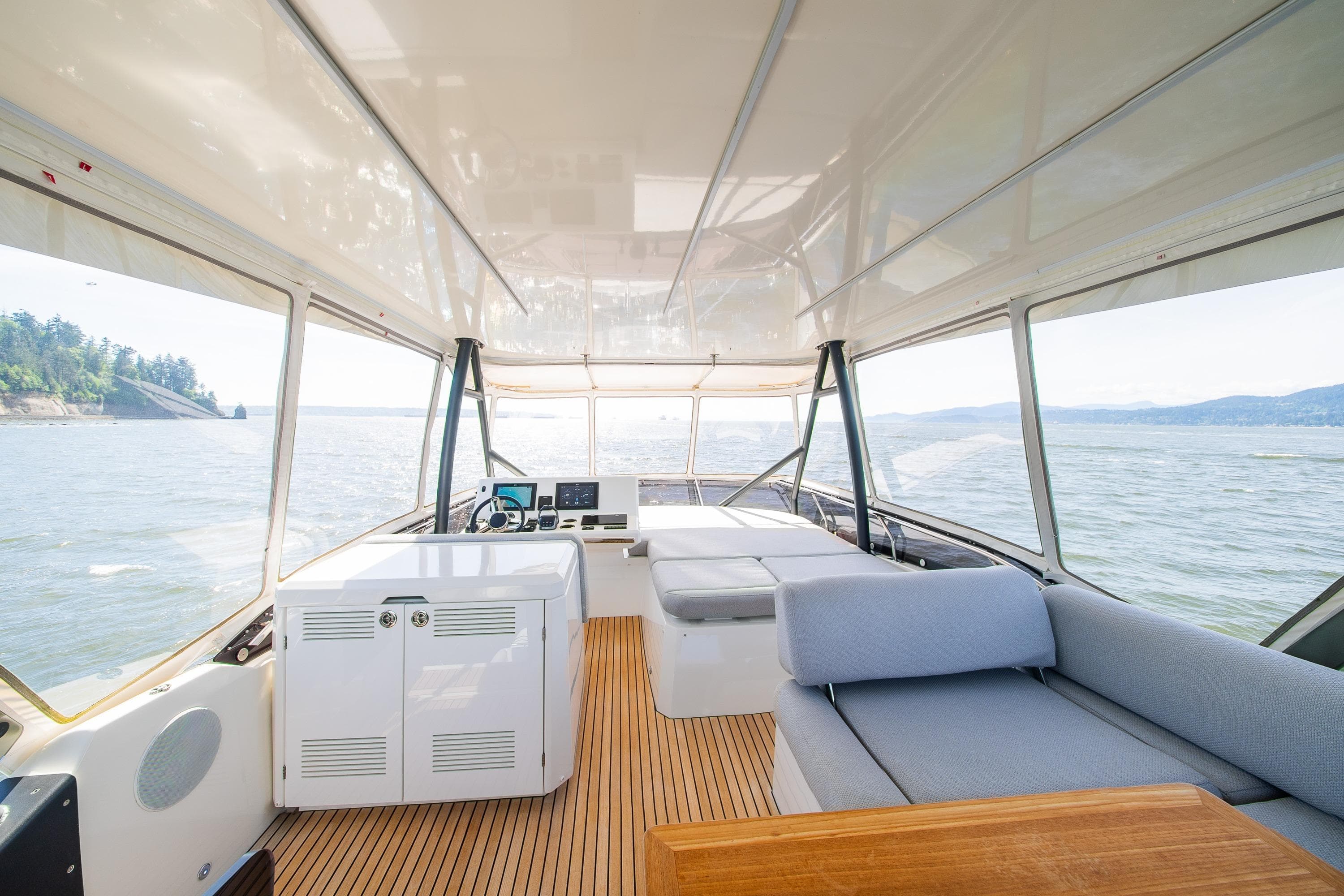 Luxurious interior of 2022 Prestige 520 yacht with panoramic windows and elegant seating.