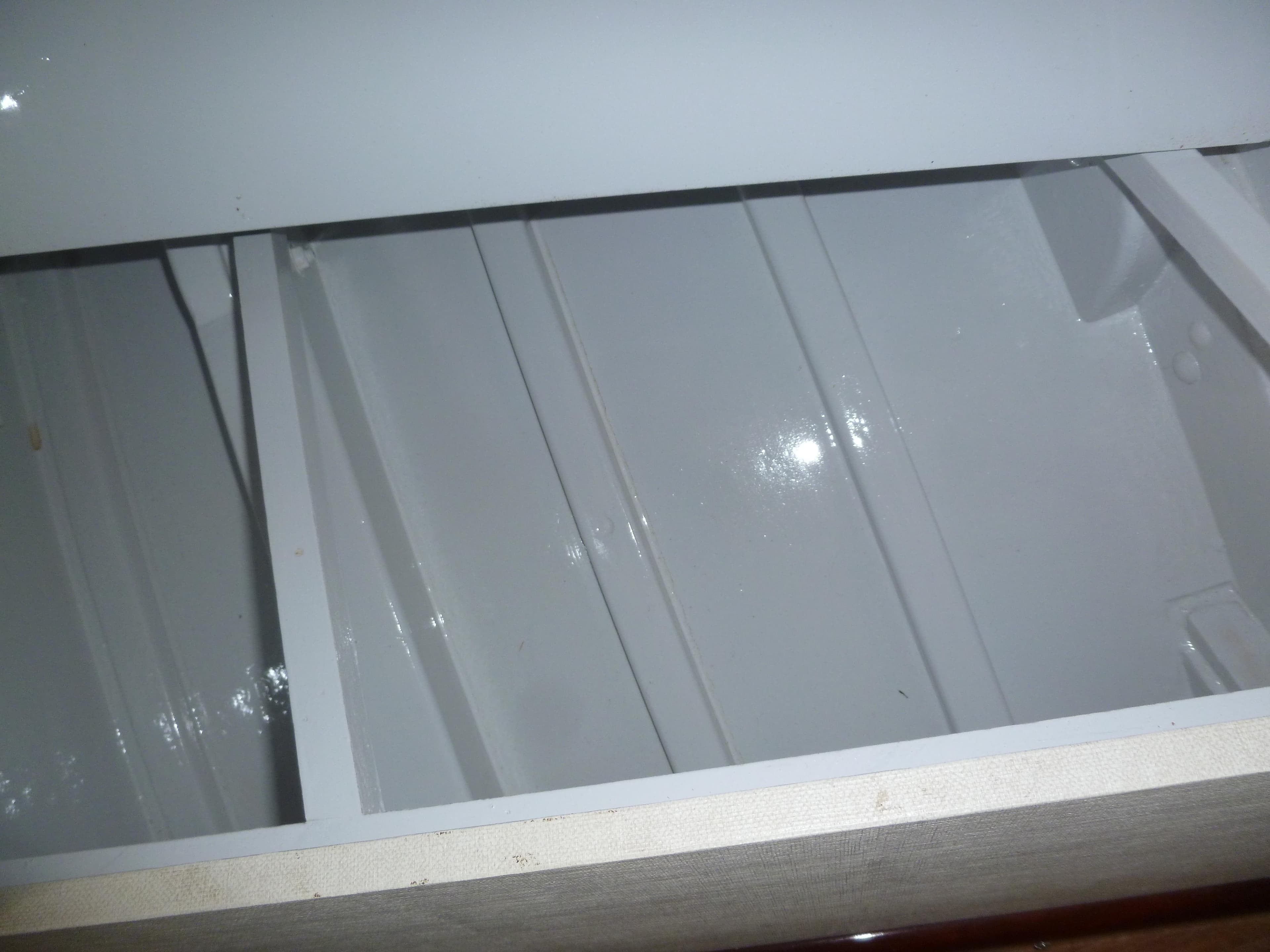 Interior view of a 1949 Rybovich Sport Fish boat, showcasing white painted surfaces.