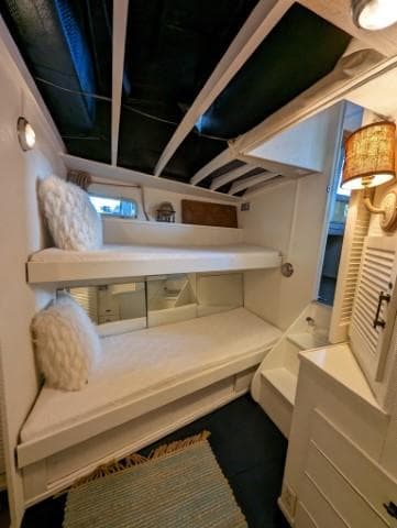 1972 Chris-Craft 41 Commander interior with cozy bunk beds and nautical decor.
