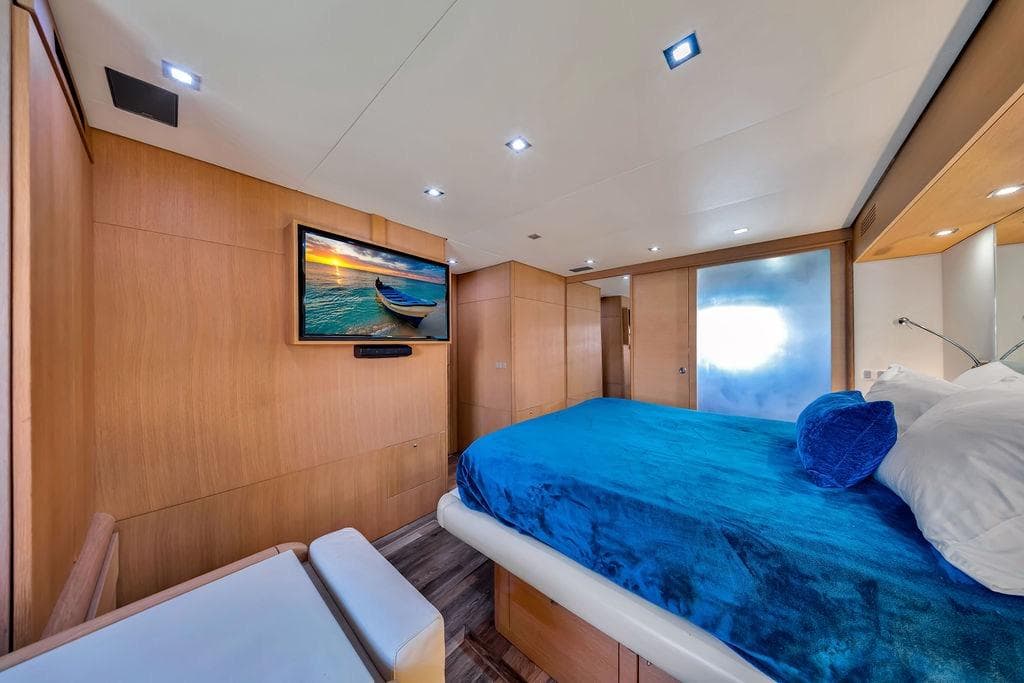 Luxurious bedroom interior of 2008 Aicon 75 yacht with modern decor and flat-screen TV.