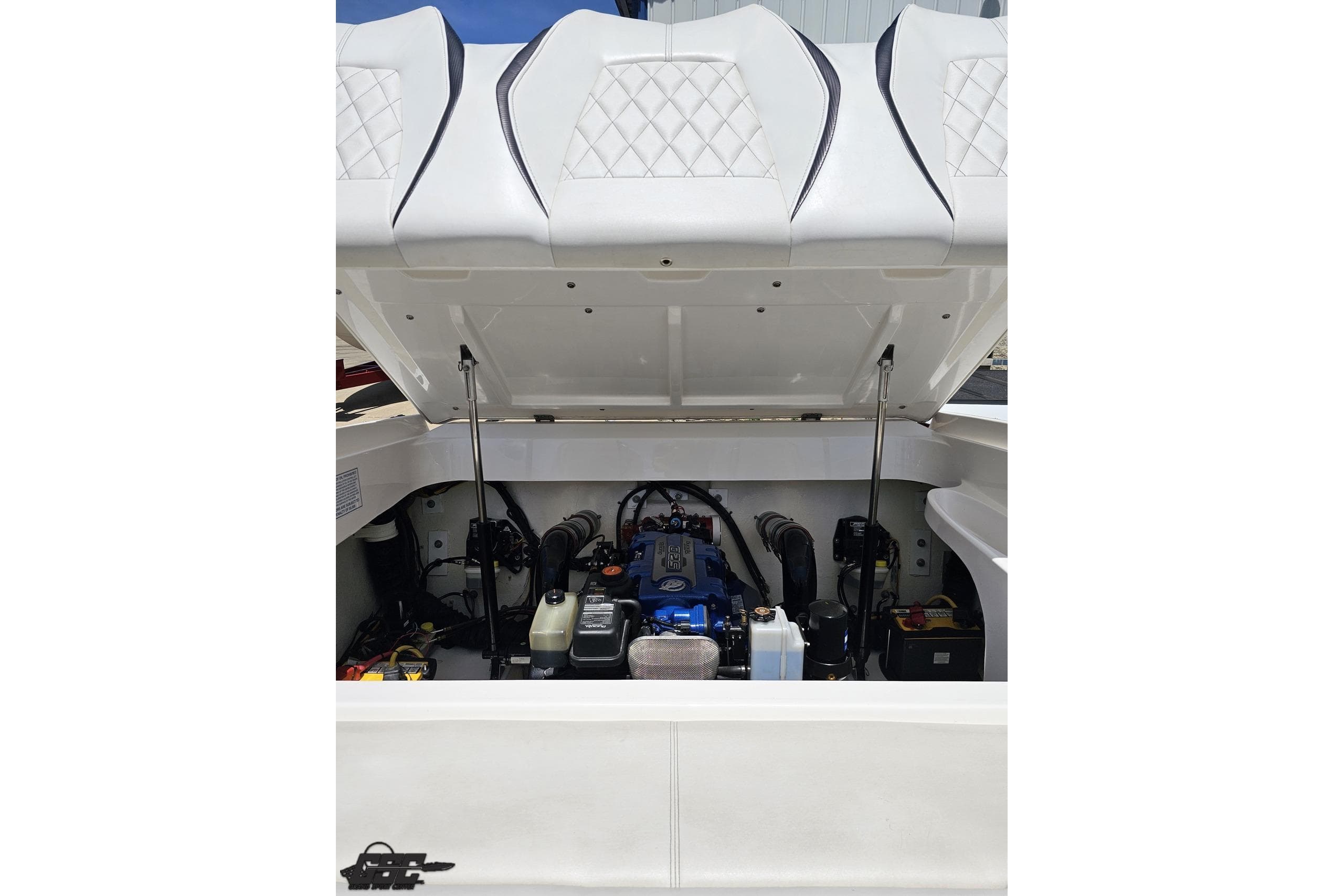 Engine compartment of a 2019 Baja 27 Outlaw boat with open hatch.