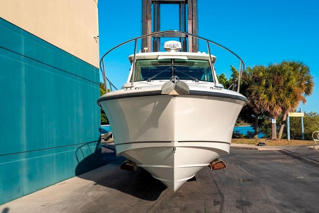2014 Boston Whaler 315 Conquest boat docked, front view, sunny day.