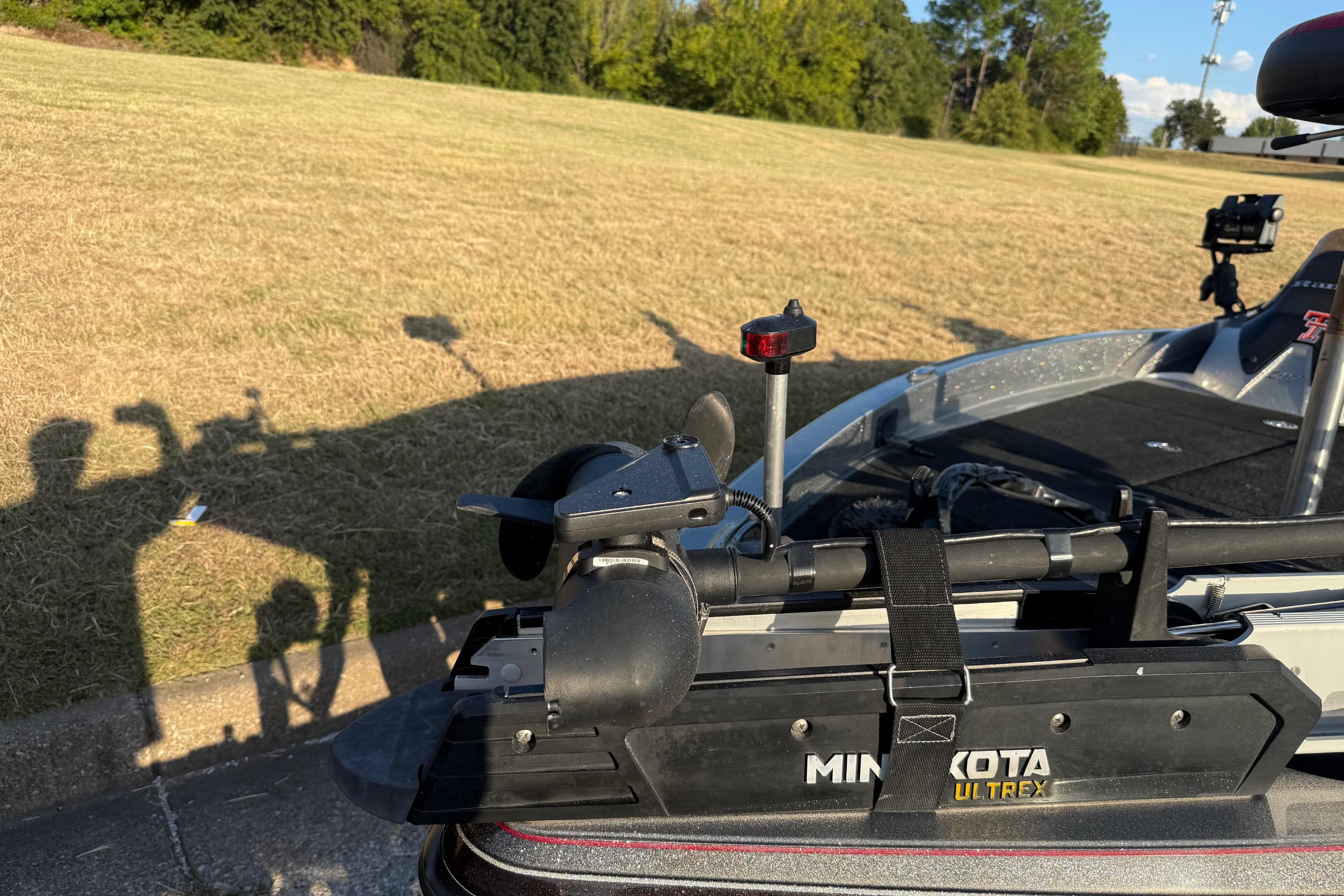 2013 Ranger Z117 boat with Minn Kota Ultrex trolling motor on grassy area.