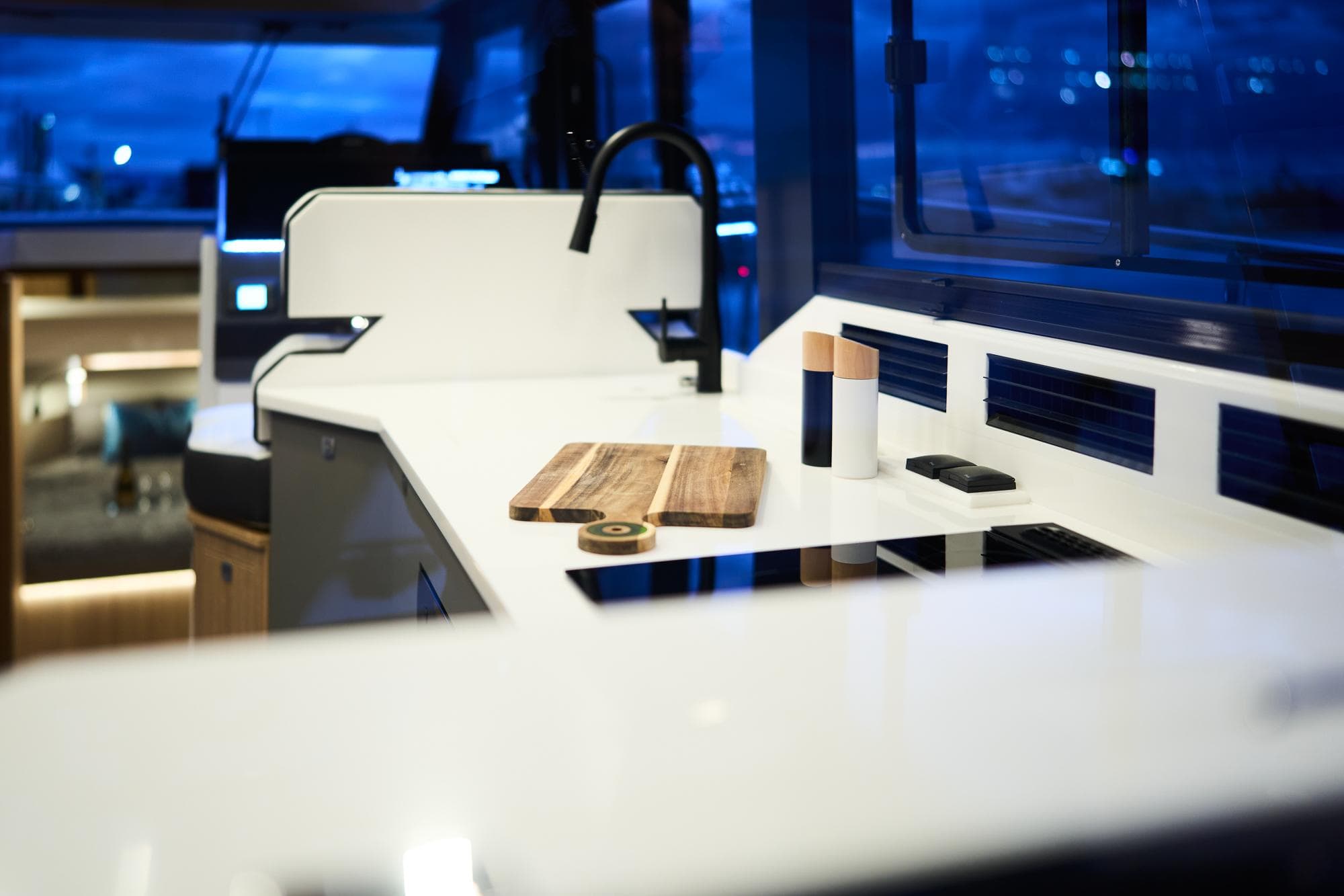 Modern kitchen interior of 2025 Northman 1300 yacht with sleek countertops and ambient lighting.