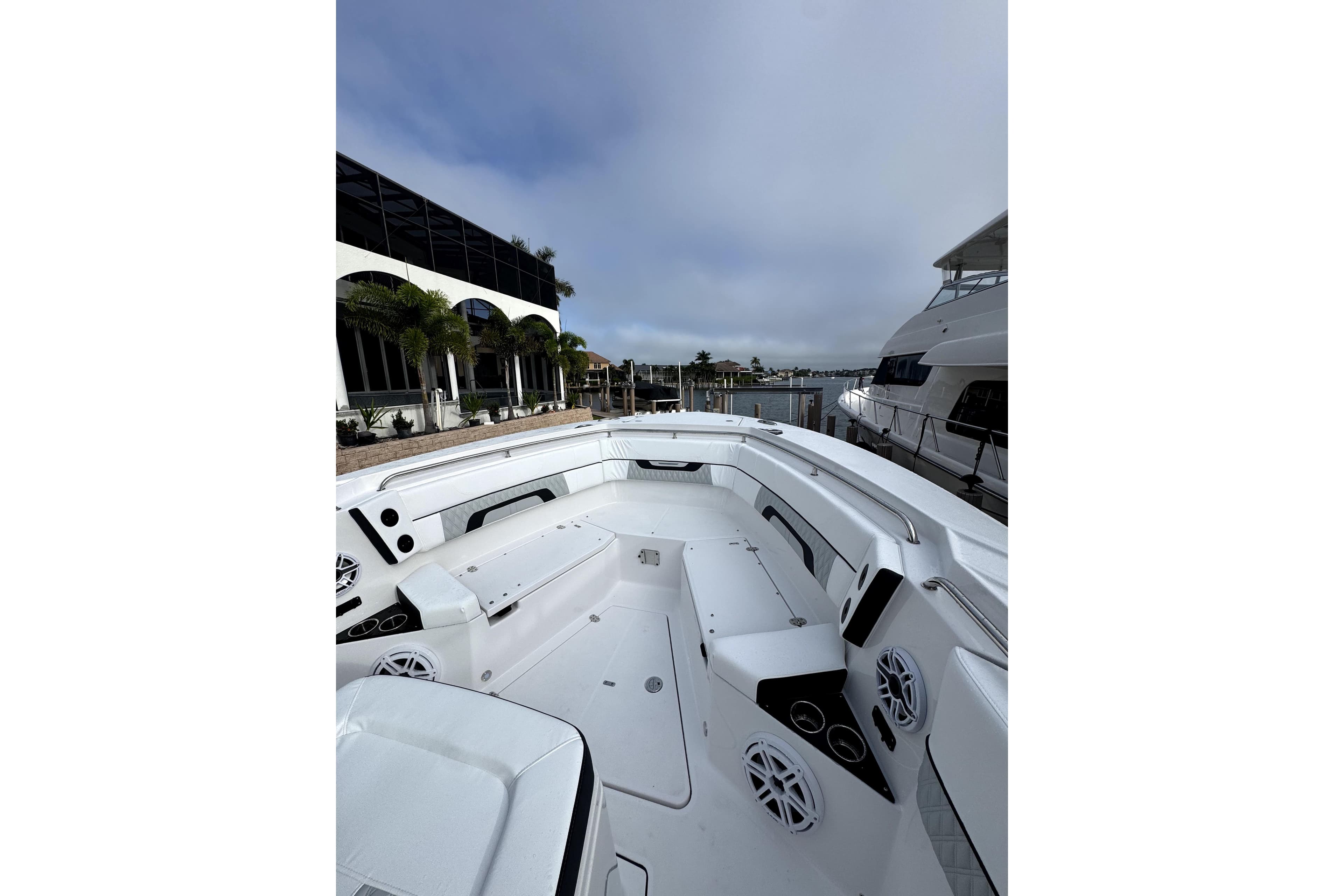 2026 Blackfin 332 CC boat interior with sleek design and modern features at a marina.