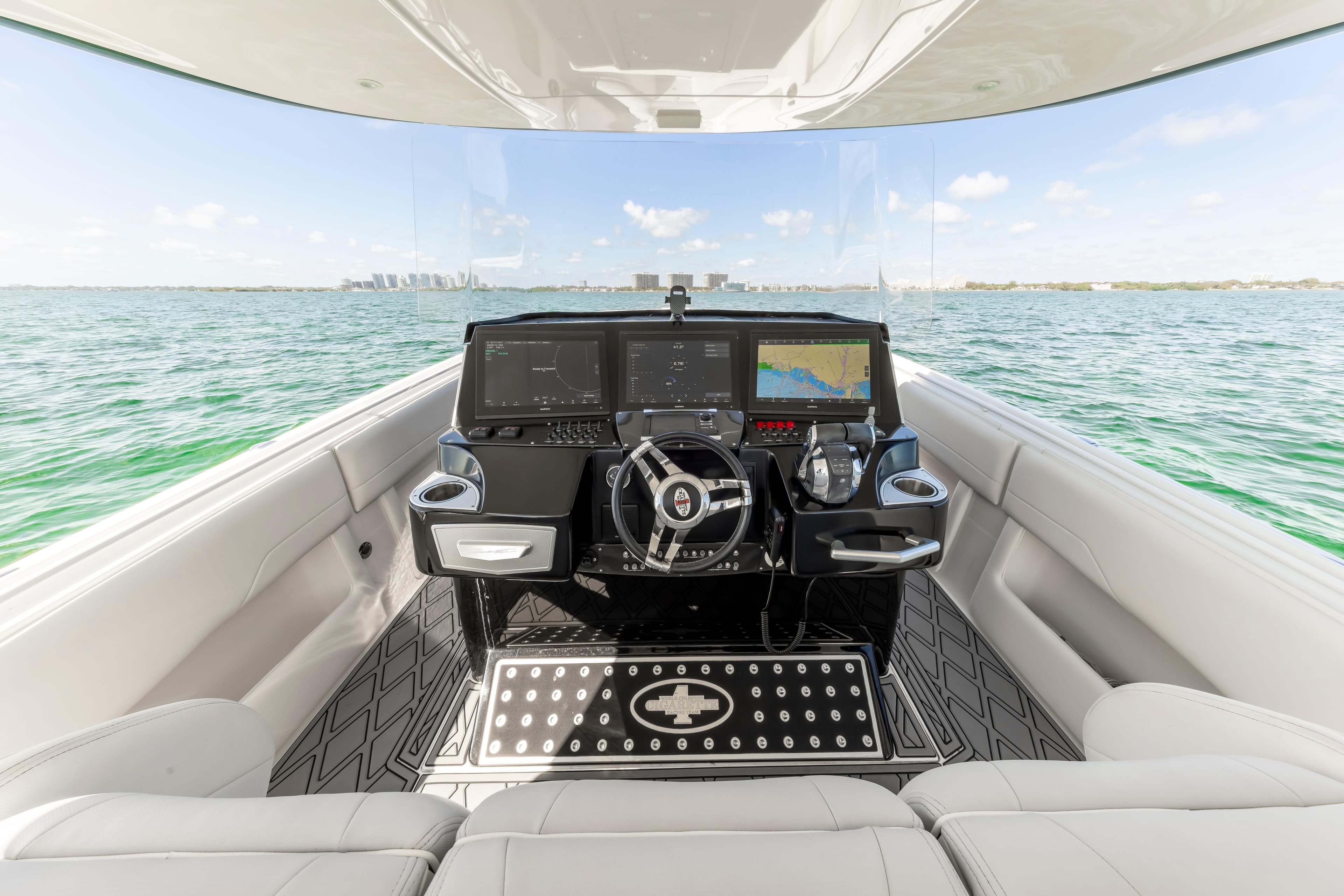 Interior view of 2016 Cigarette 41 GTR boat with modern dashboard and ocean backdrop.