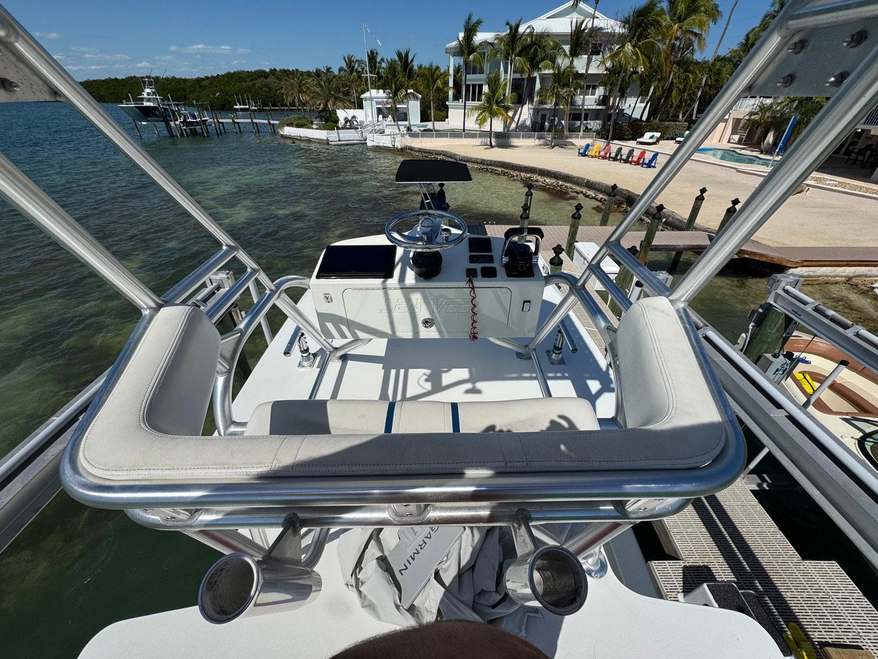 2014 SeaVee 390B Center Console boat docked near a tropical waterfront home.