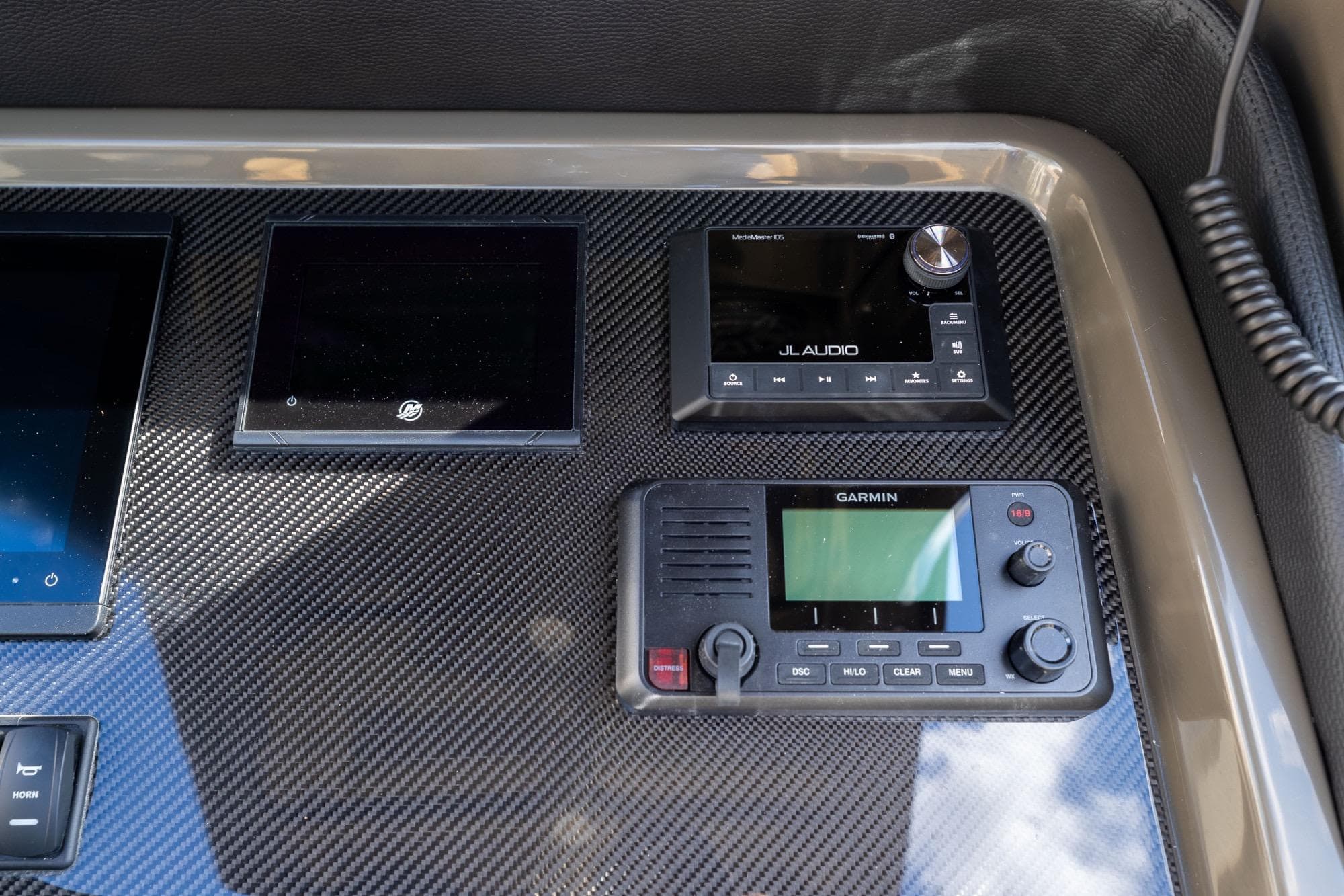 Control panel of 2023 Airship 310 featuring JL Audio and Garmin devices.