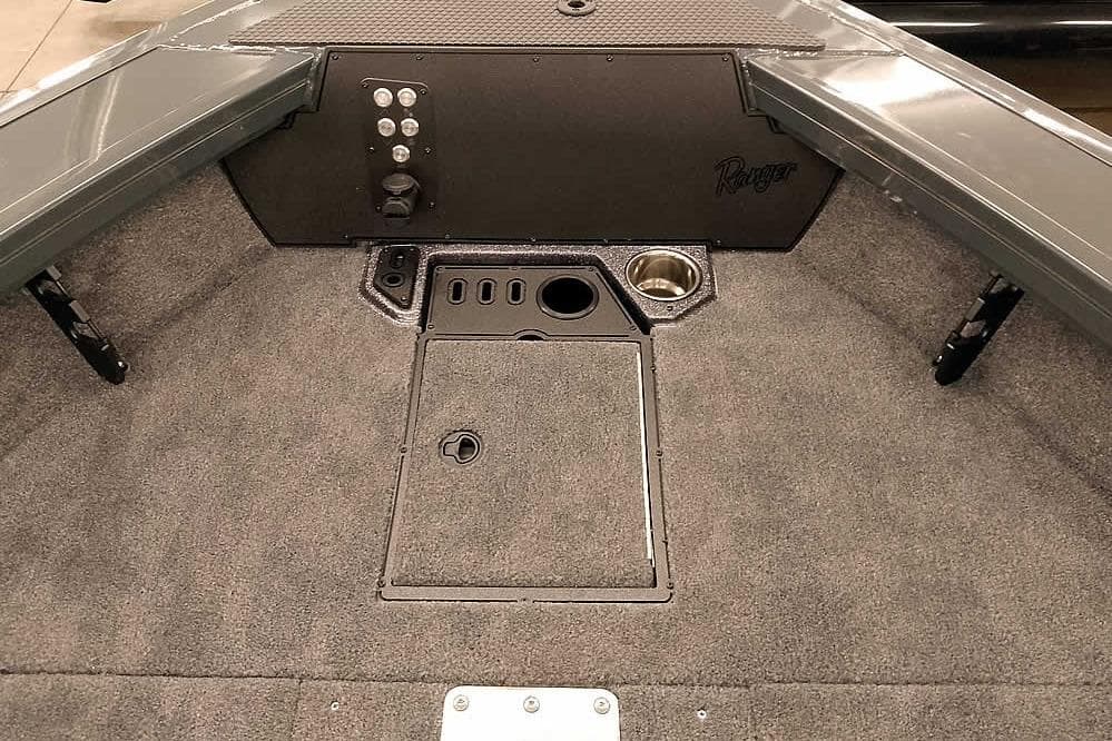 Interior of 2026 Ranger VX1988 WT boat with carpeted deck and storage compartments.