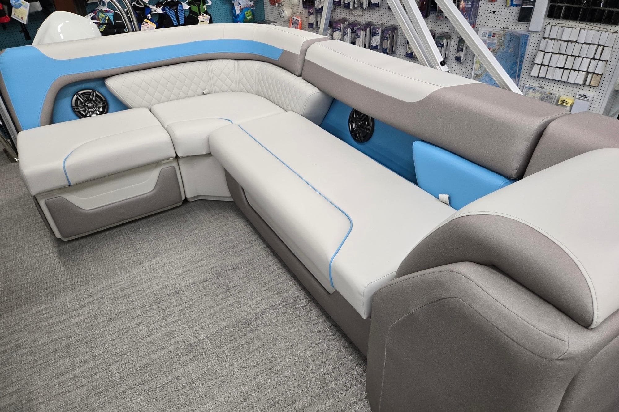 Luxurious seating on 2026 Godfrey Sweetwater 2086 C pontoon boat, featuring modern design and speakers.