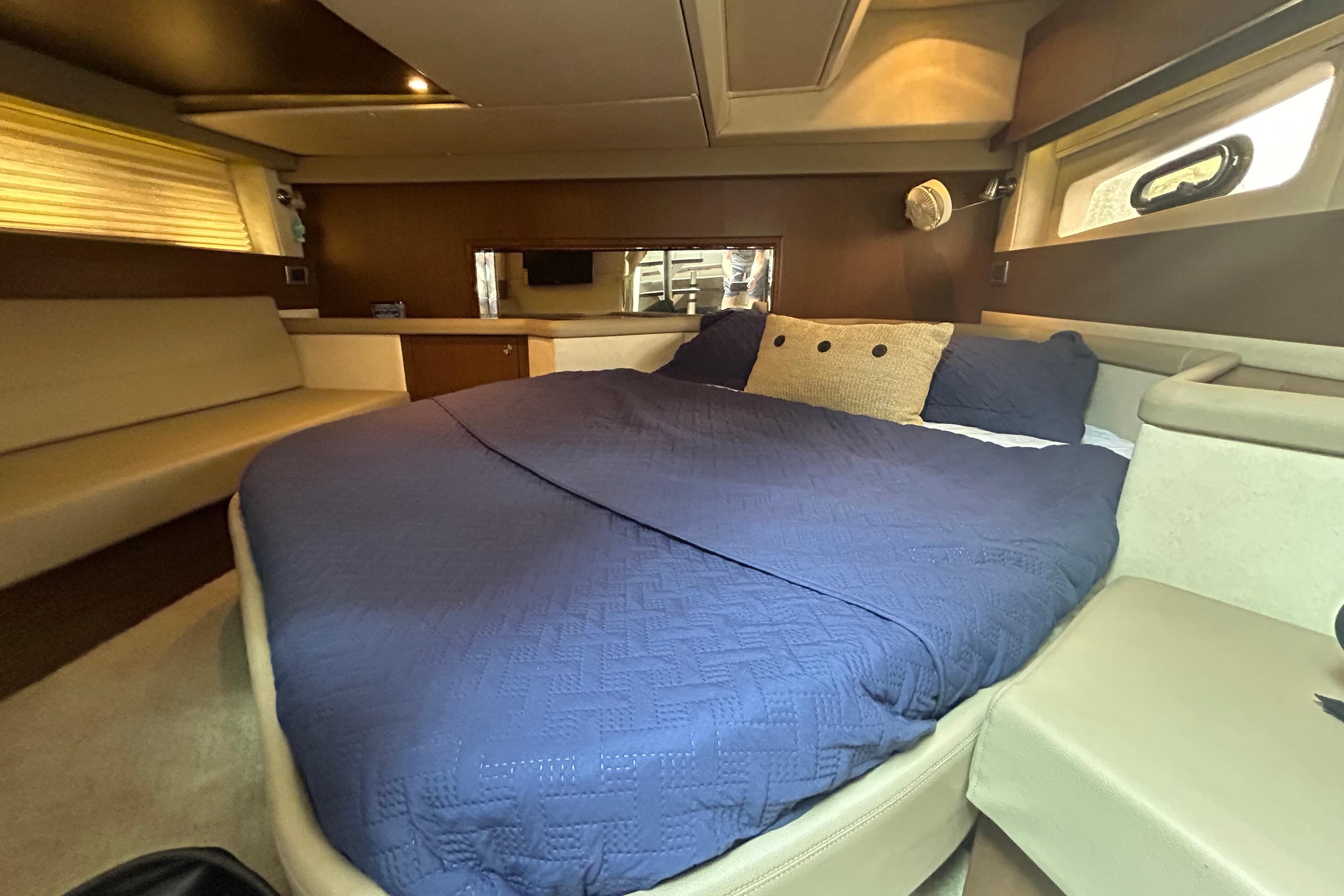 Luxurious cabin interior of 2014 Sea Ray 370 Venture with cozy bed and modern design.