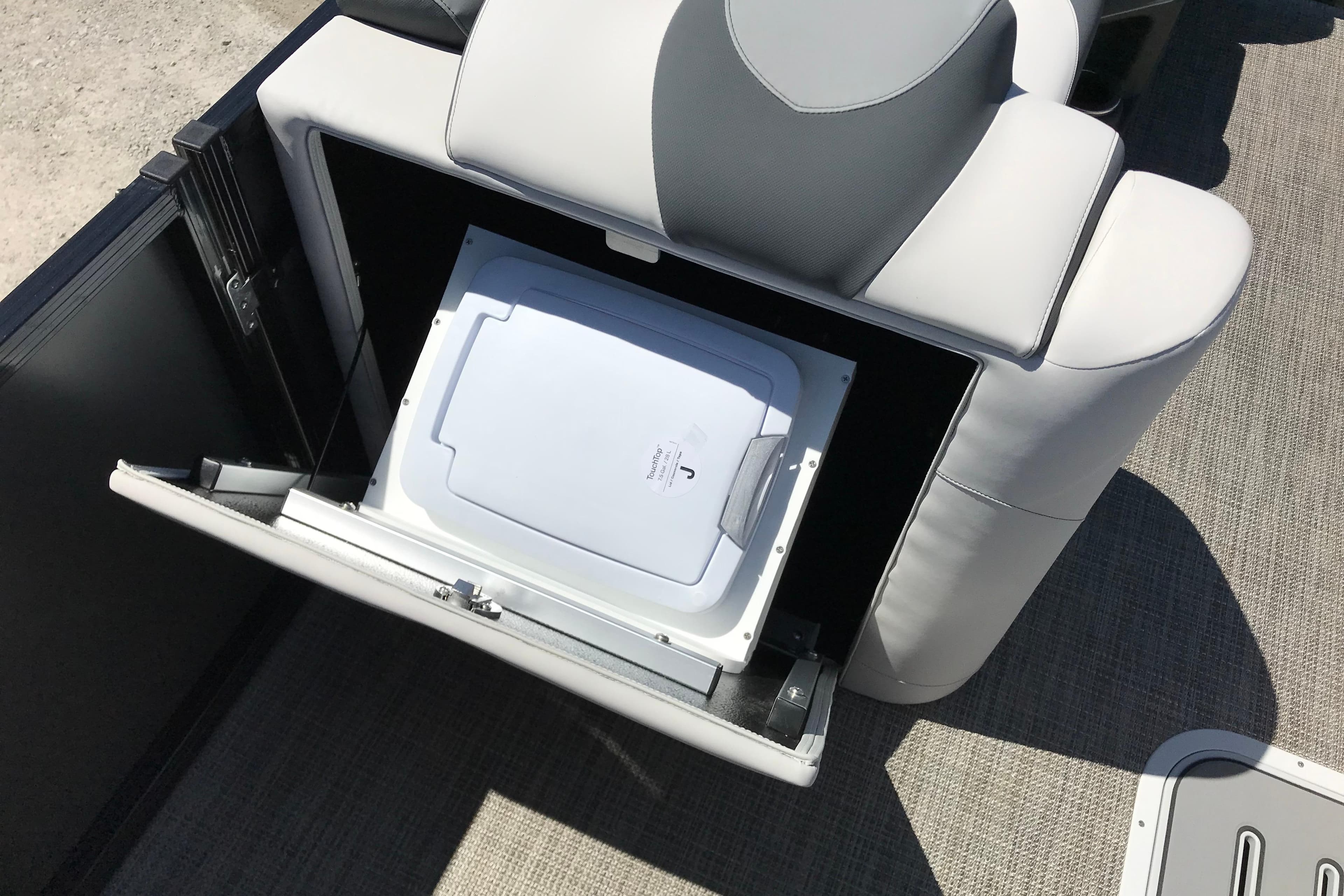 2026 Avalon LSZ Quad Lounge boat seat with integrated storage compartment open.