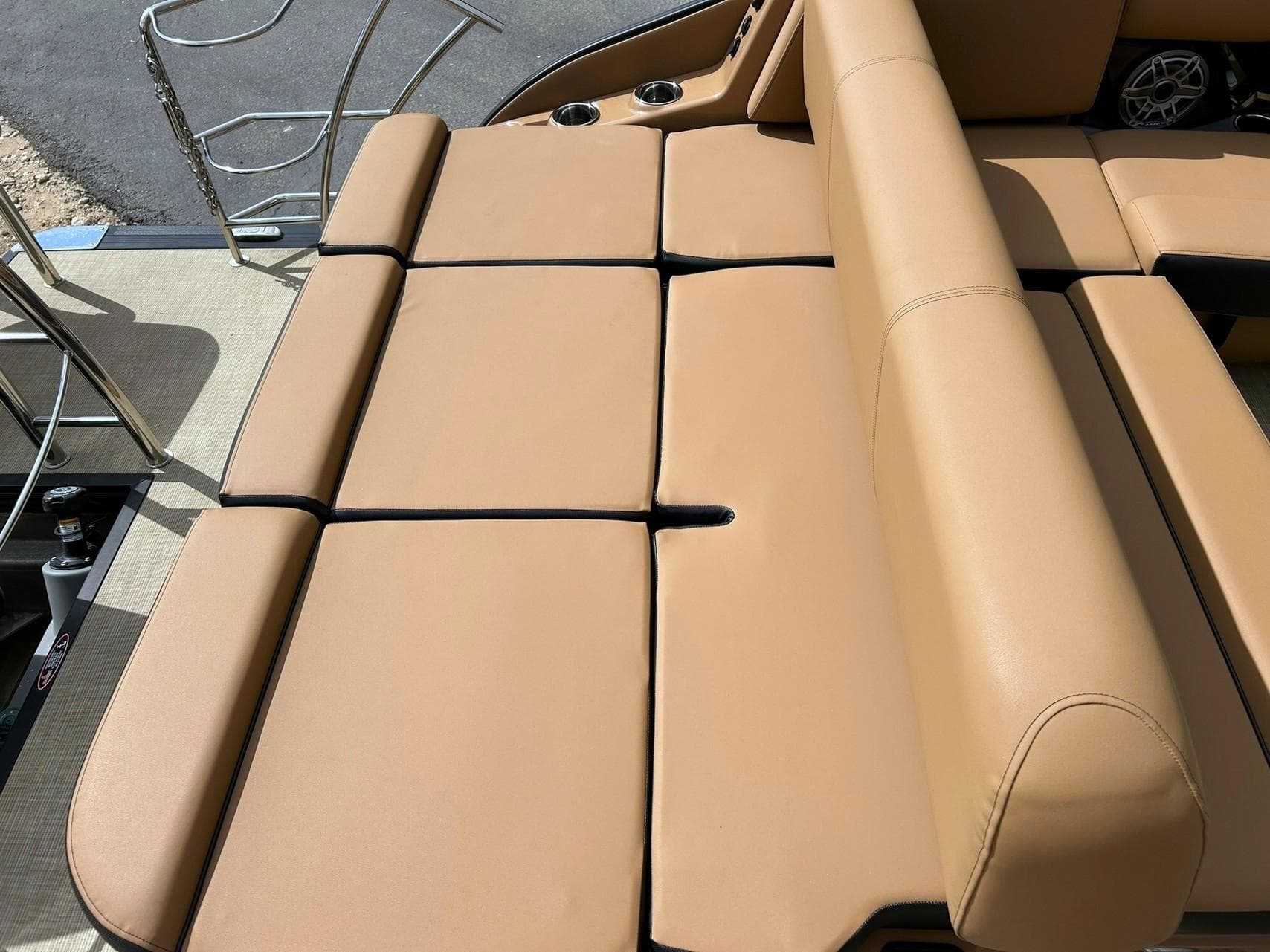 2023 Harris Grand Mariner 230 boat with tan cushioned seating and stainless steel railings.