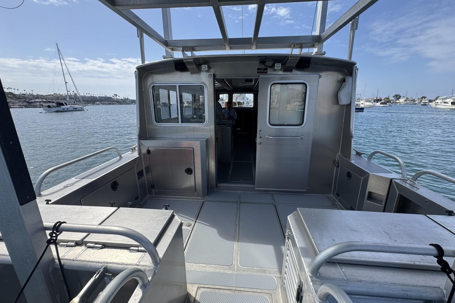 2015 Armstrong Marine Power Cat on water, showcasing spacious deck and cabin.