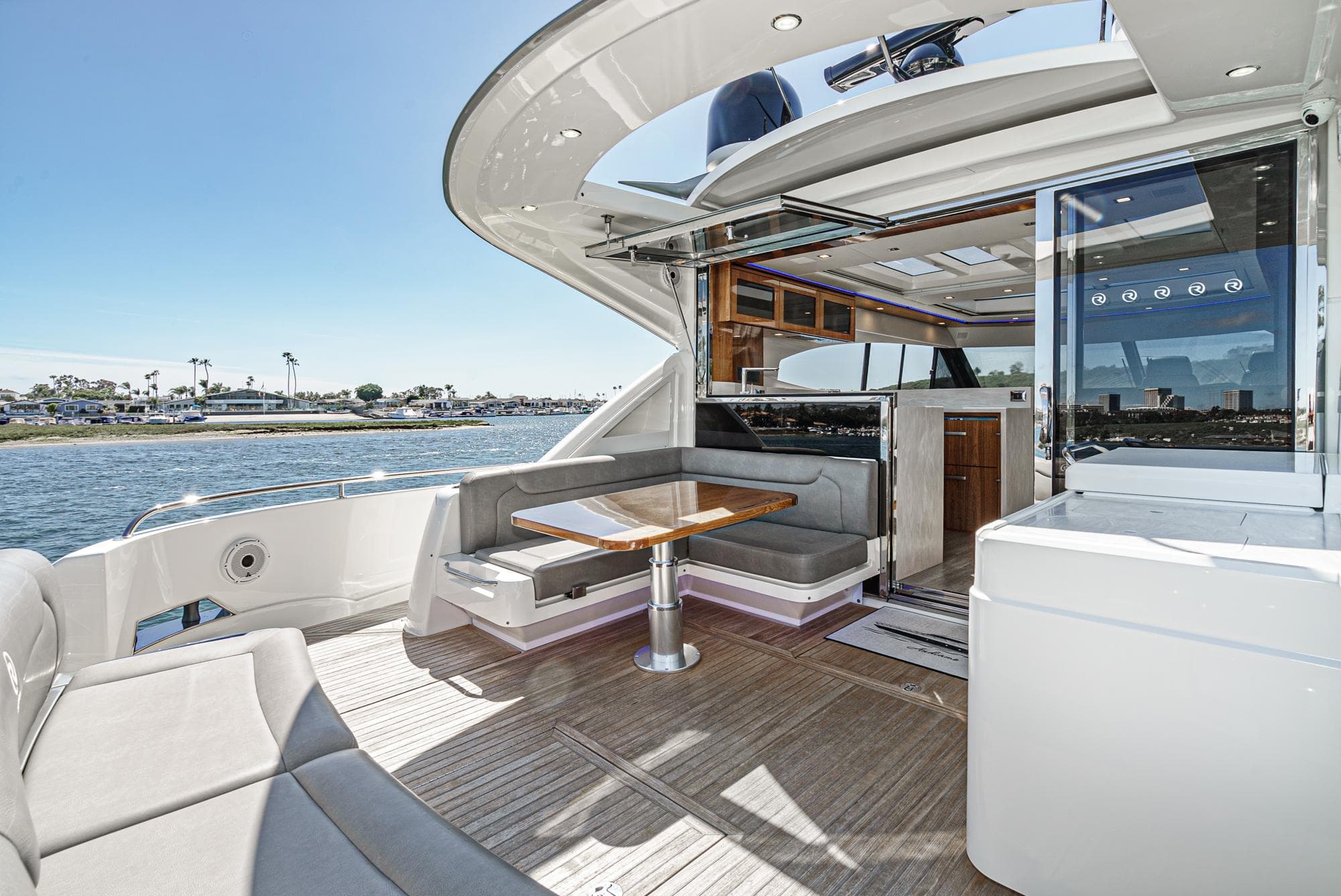 2020 Riviera 6000 Sport Yacht with spacious deck and luxurious interior on the water.