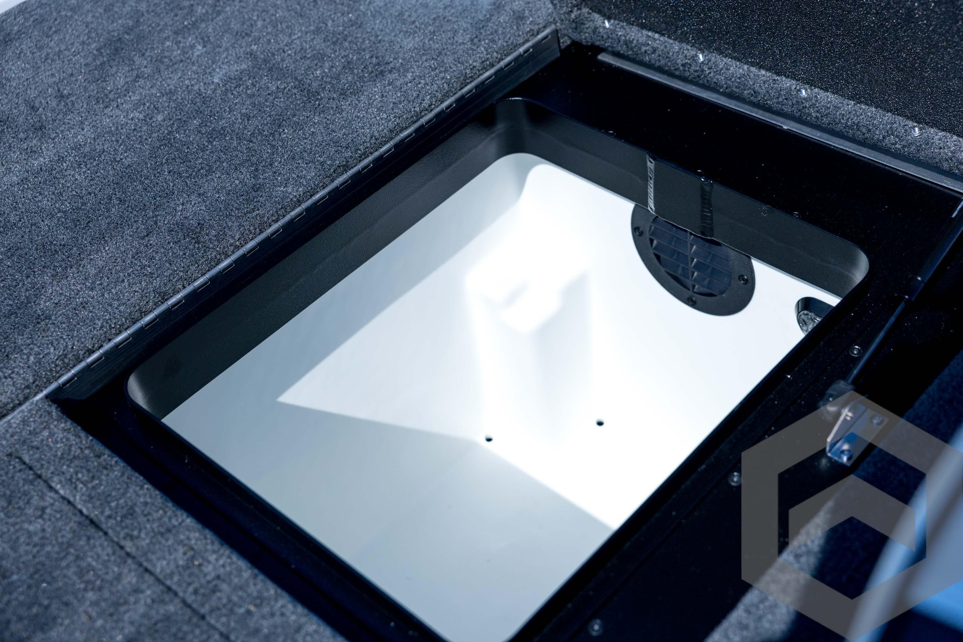 2026 Skeeter ZXE21 boat storage compartment with carpeted interior and ventilation.