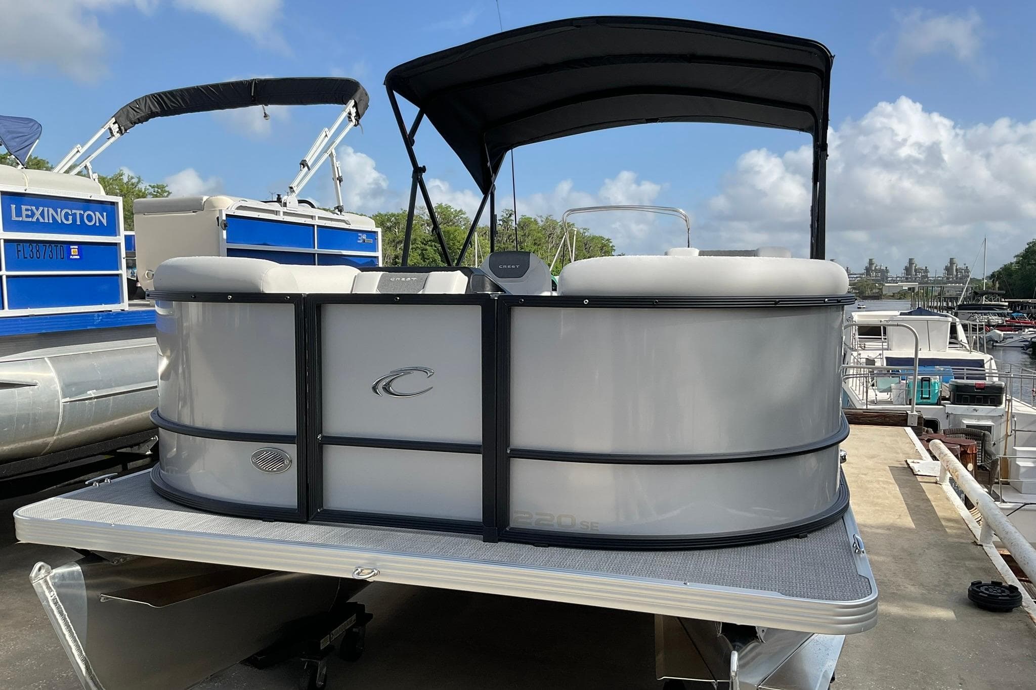 2026 Crest Conquest SE 220 Cruise pontoon boat docked under a clear sky.