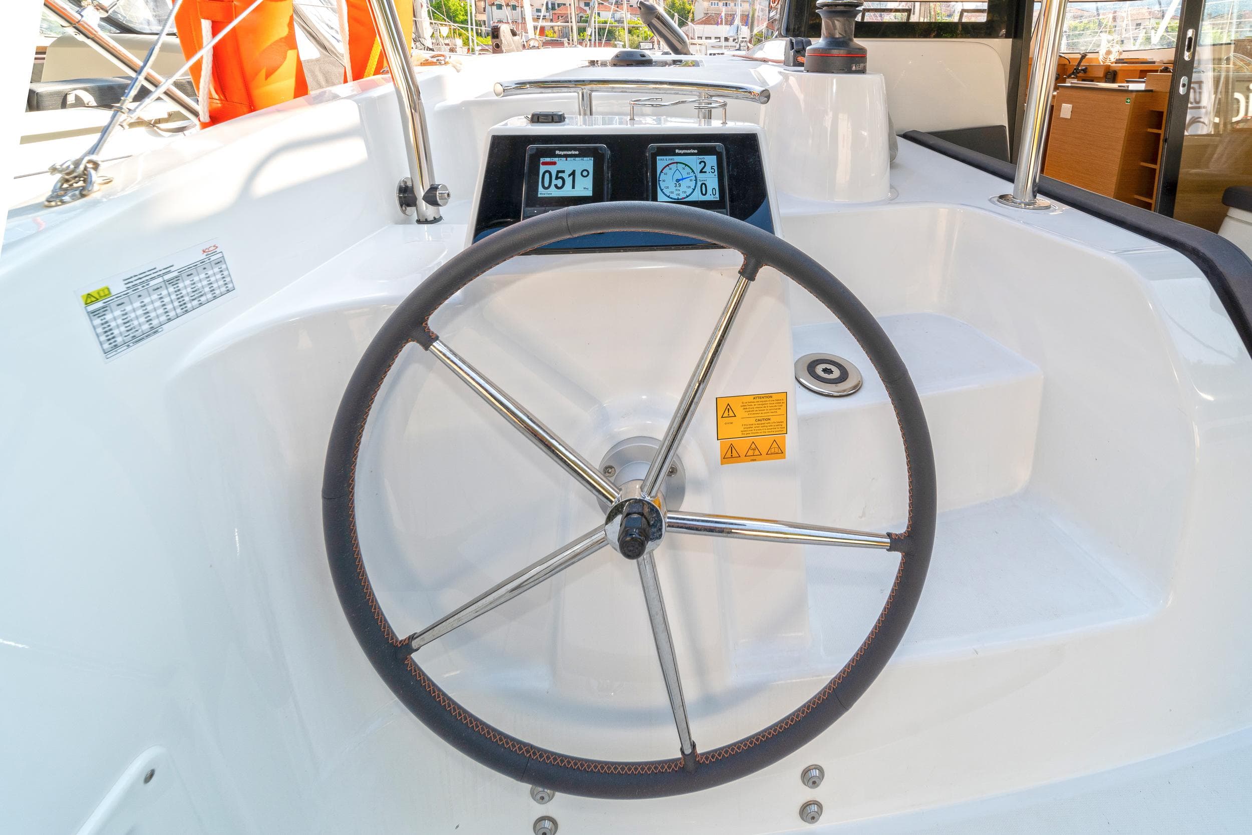 Steering wheel of 2023 Excess 11 catamaran with digital display and controls.