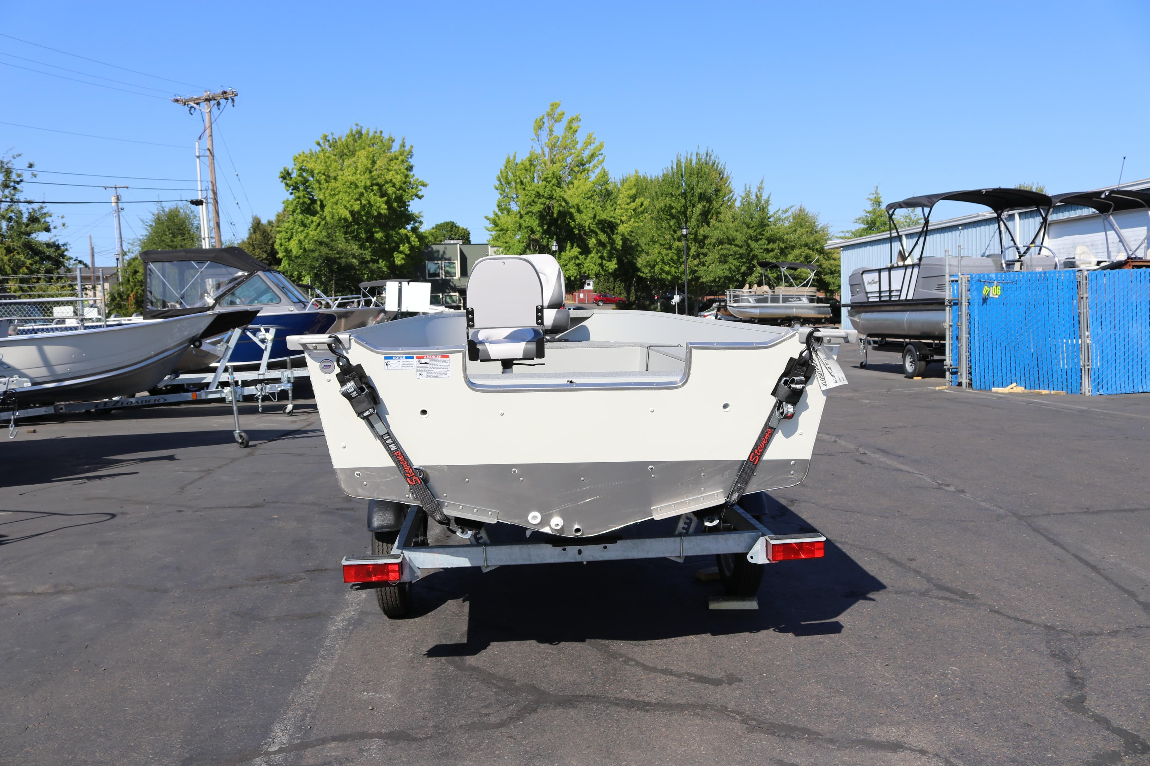 2025 Smoker Craft Angler 16 XL TL boat on trailer in outdoor lot.