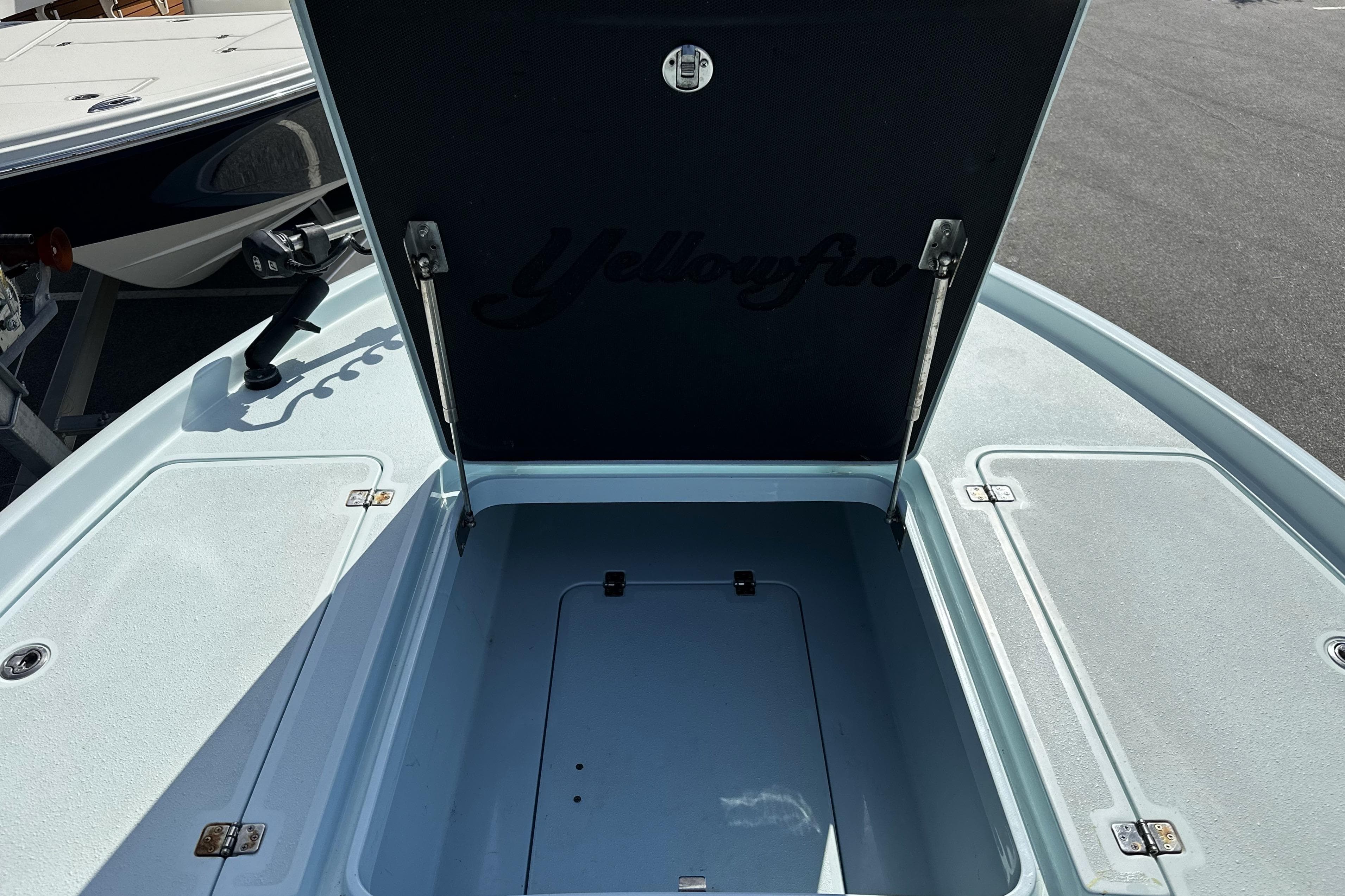 2017 Yellowfin 24 Bay CE boat with open storage compartment on deck.