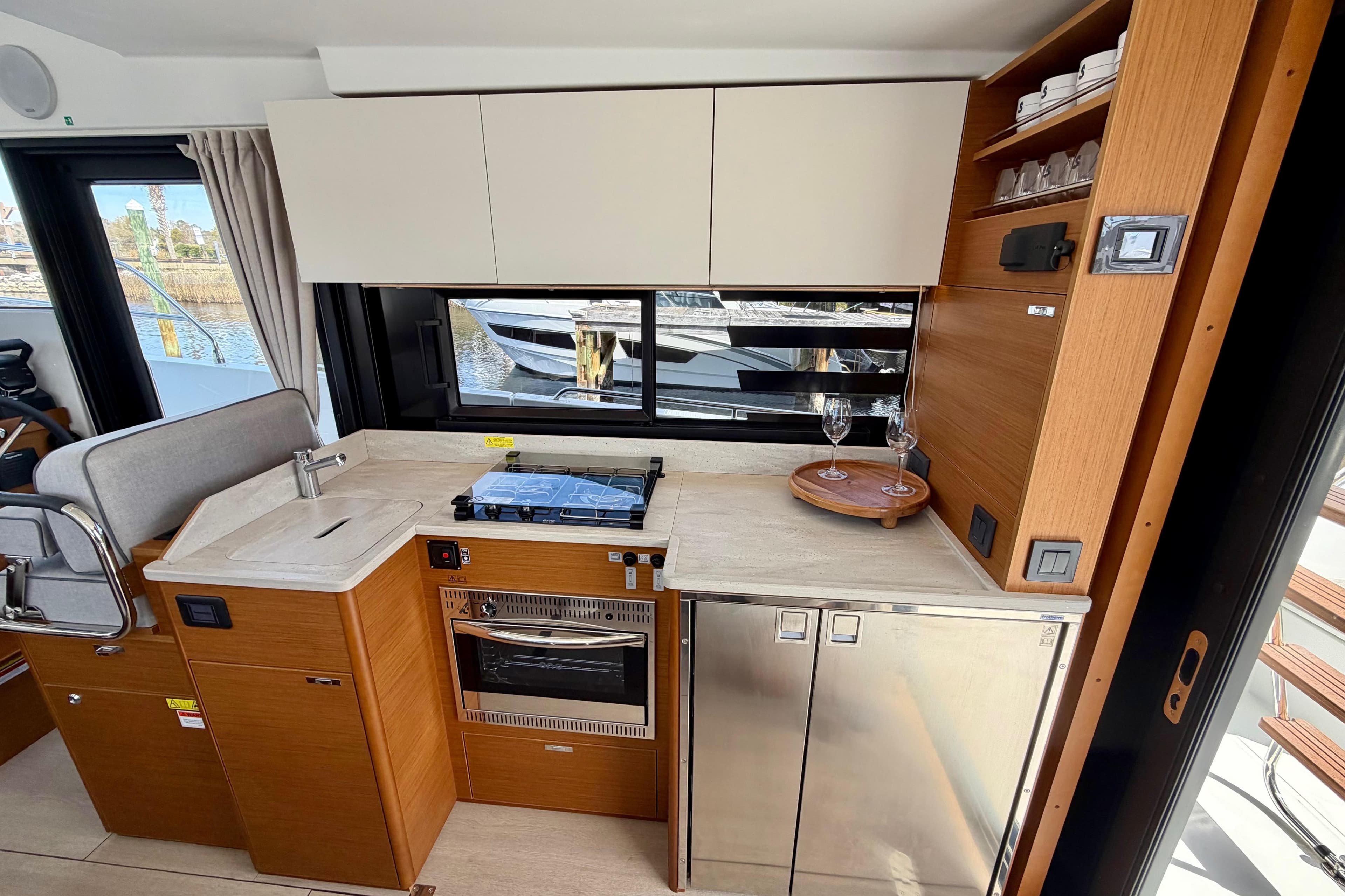 Modern kitchen interior of 2026 Beneteau Swift Trawler 37 Fly yacht.