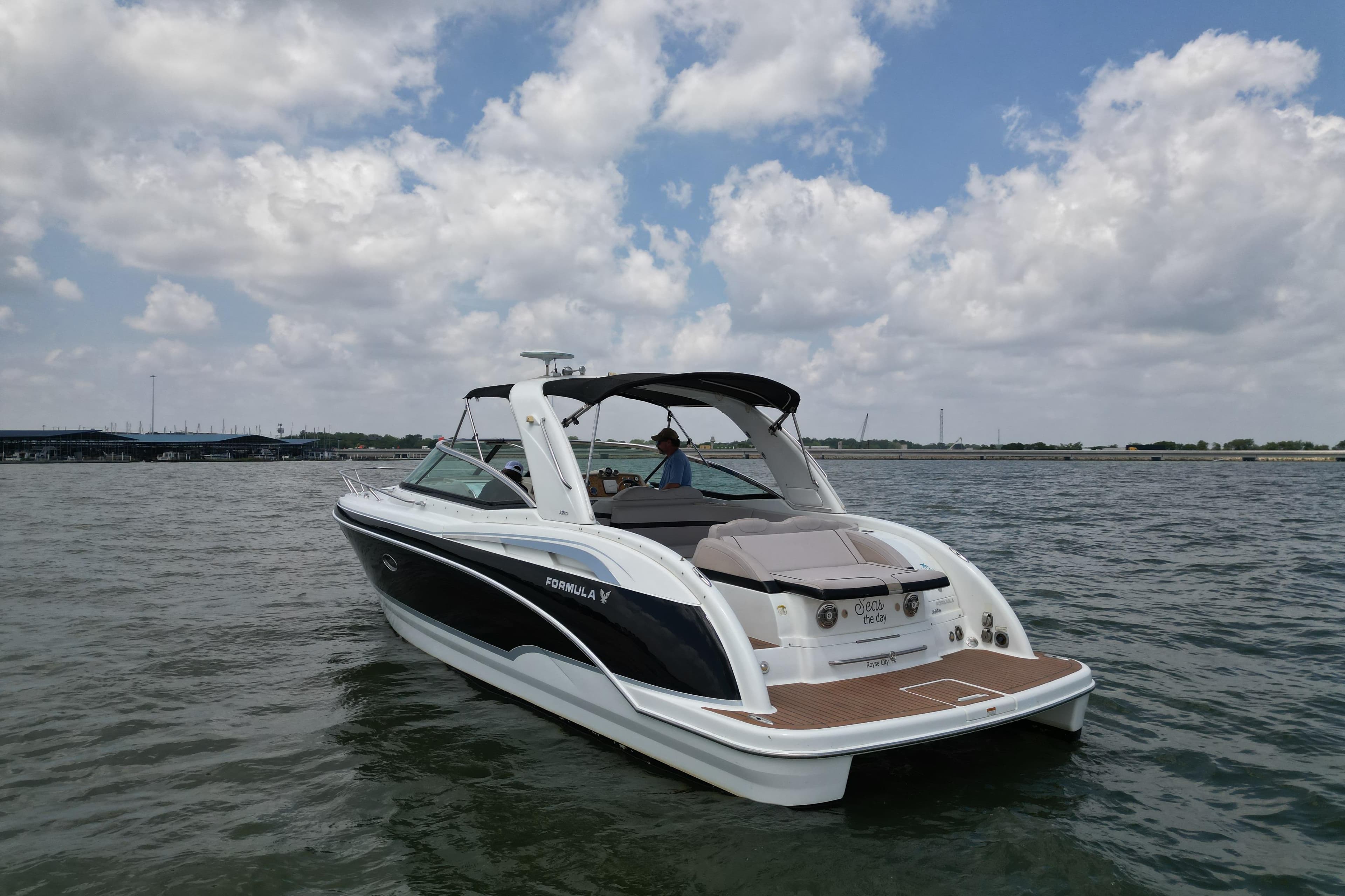 2008 Formula 350 Sun Sport boat on water under cloudy sky.