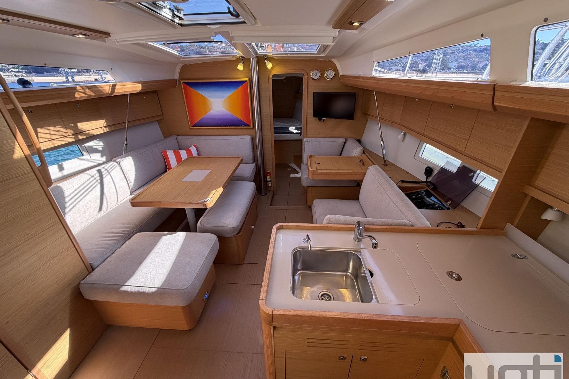 Interior of 2018 Dufour 410 yacht with modern kitchen and seating area.