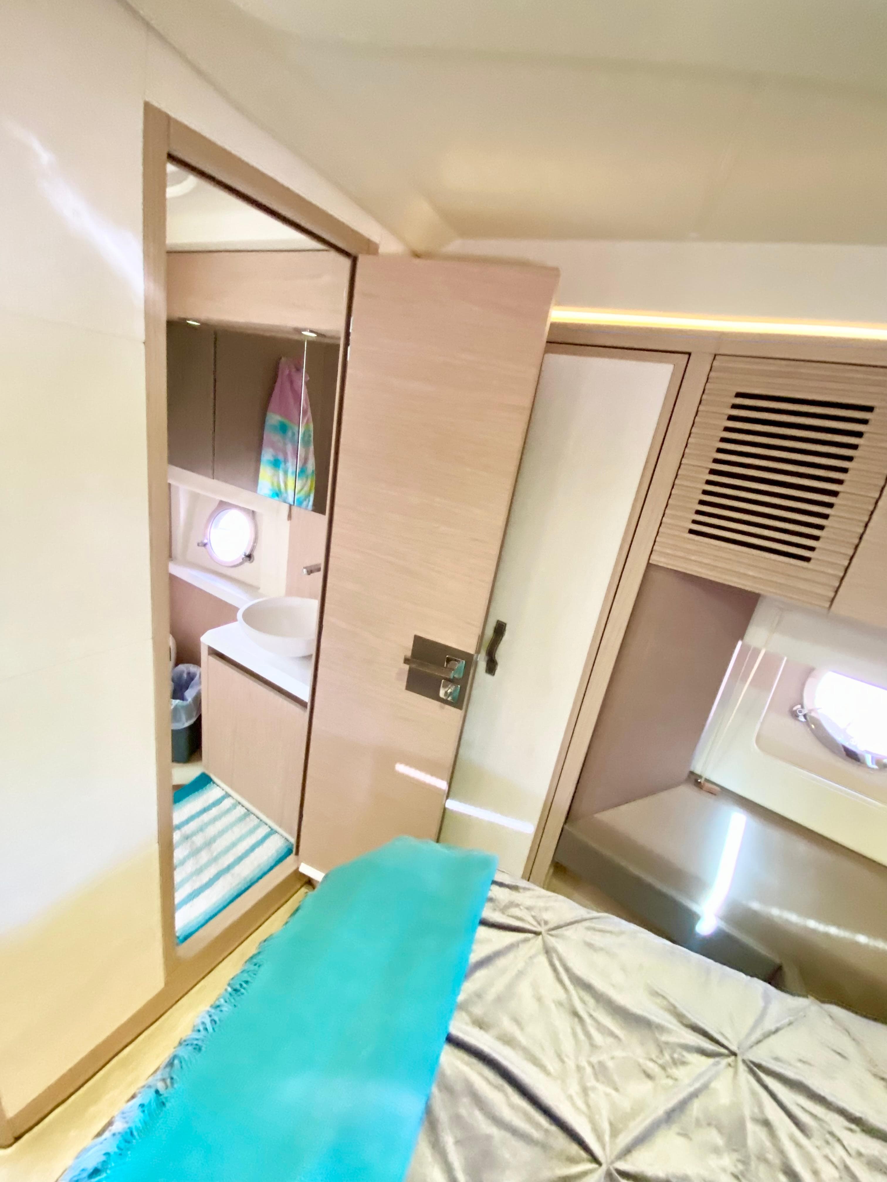 2015 Monte Carlo MC5S yacht interior with modern bedroom and bathroom design.