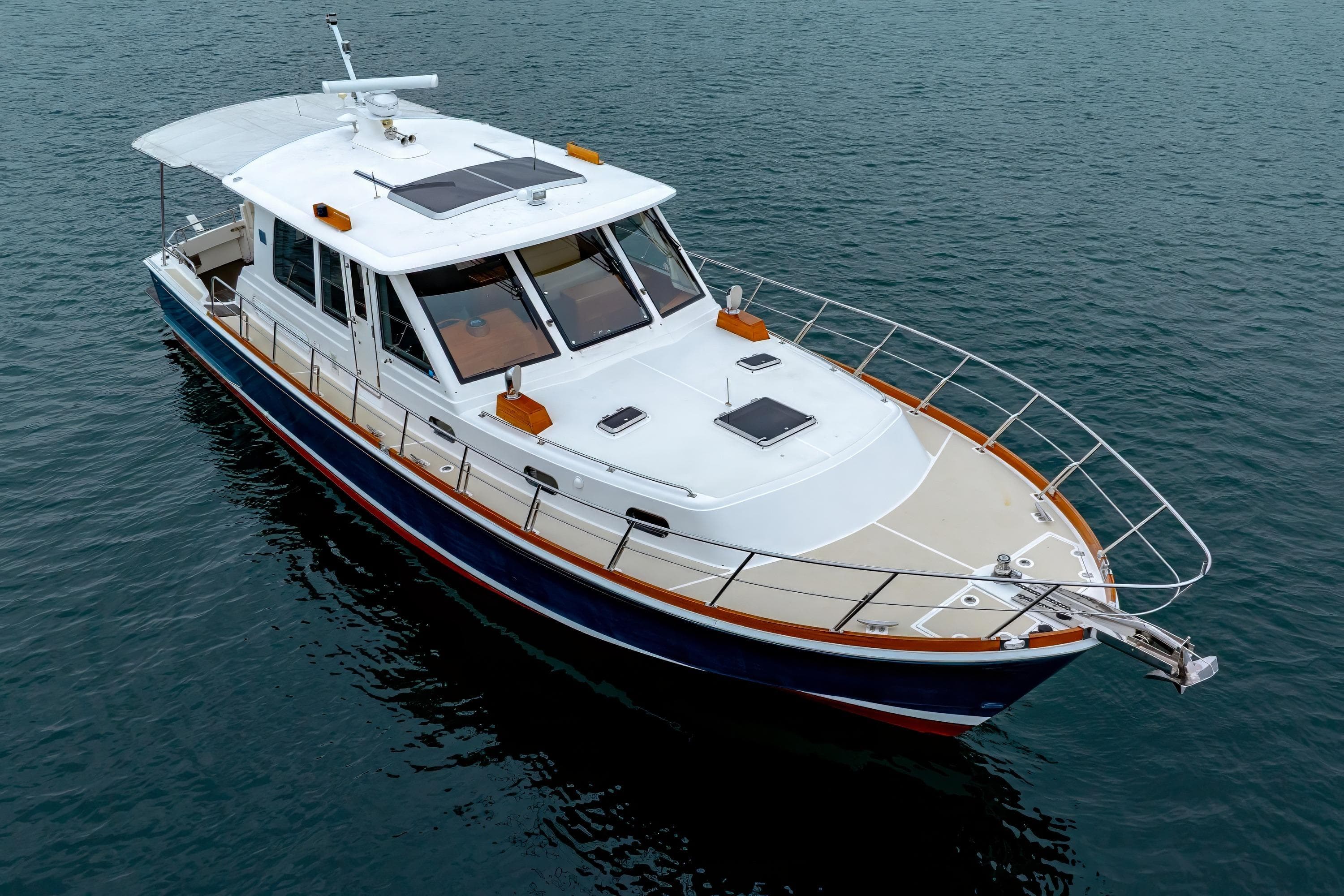 2014 Grand Banks 46 Eastbay SX yacht on calm water, showcasing sleek design and luxury features.