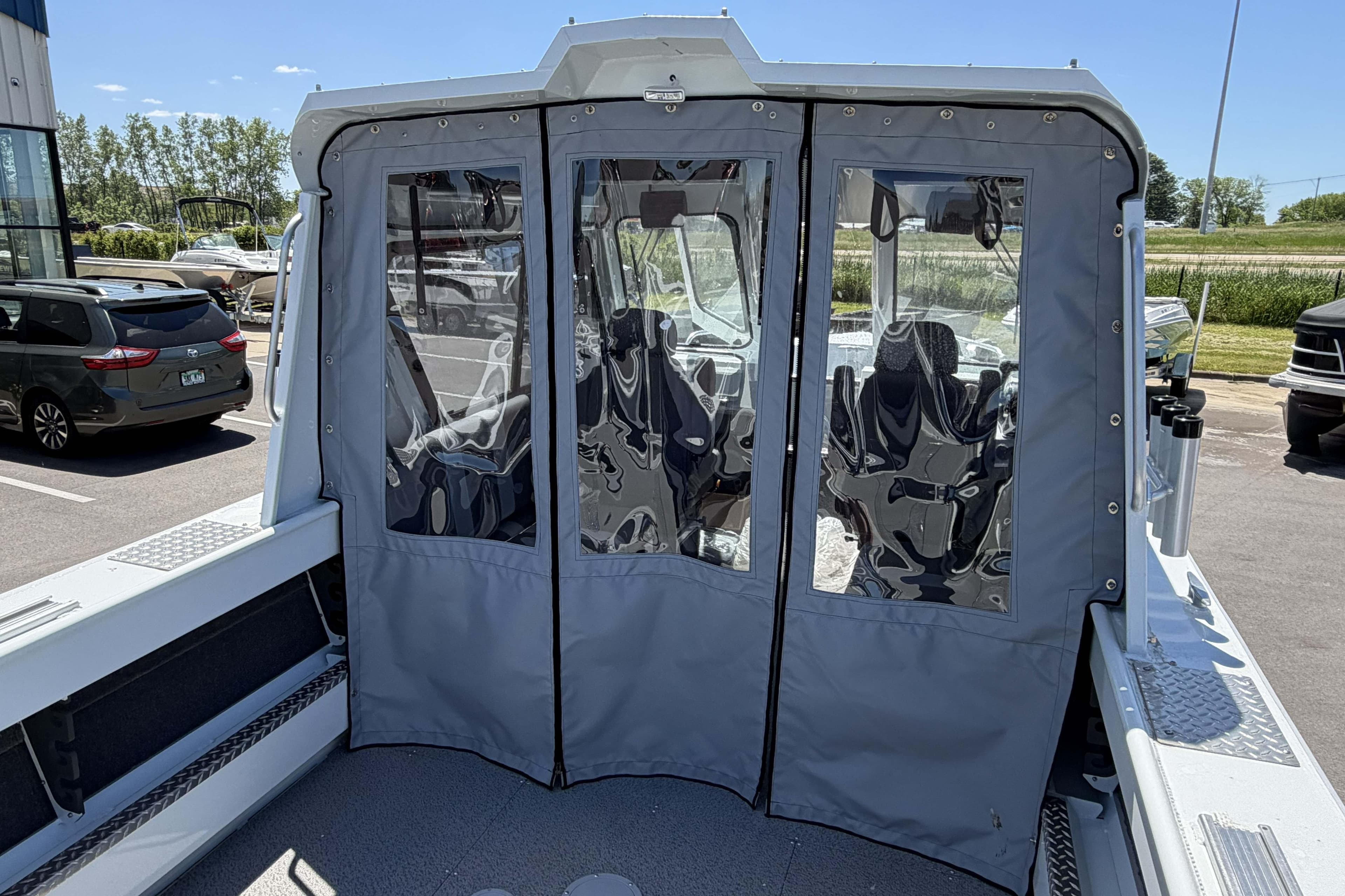 2026 Hewescraft 240 Ocean Pro ET Hardtop with protective canvas enclosure.