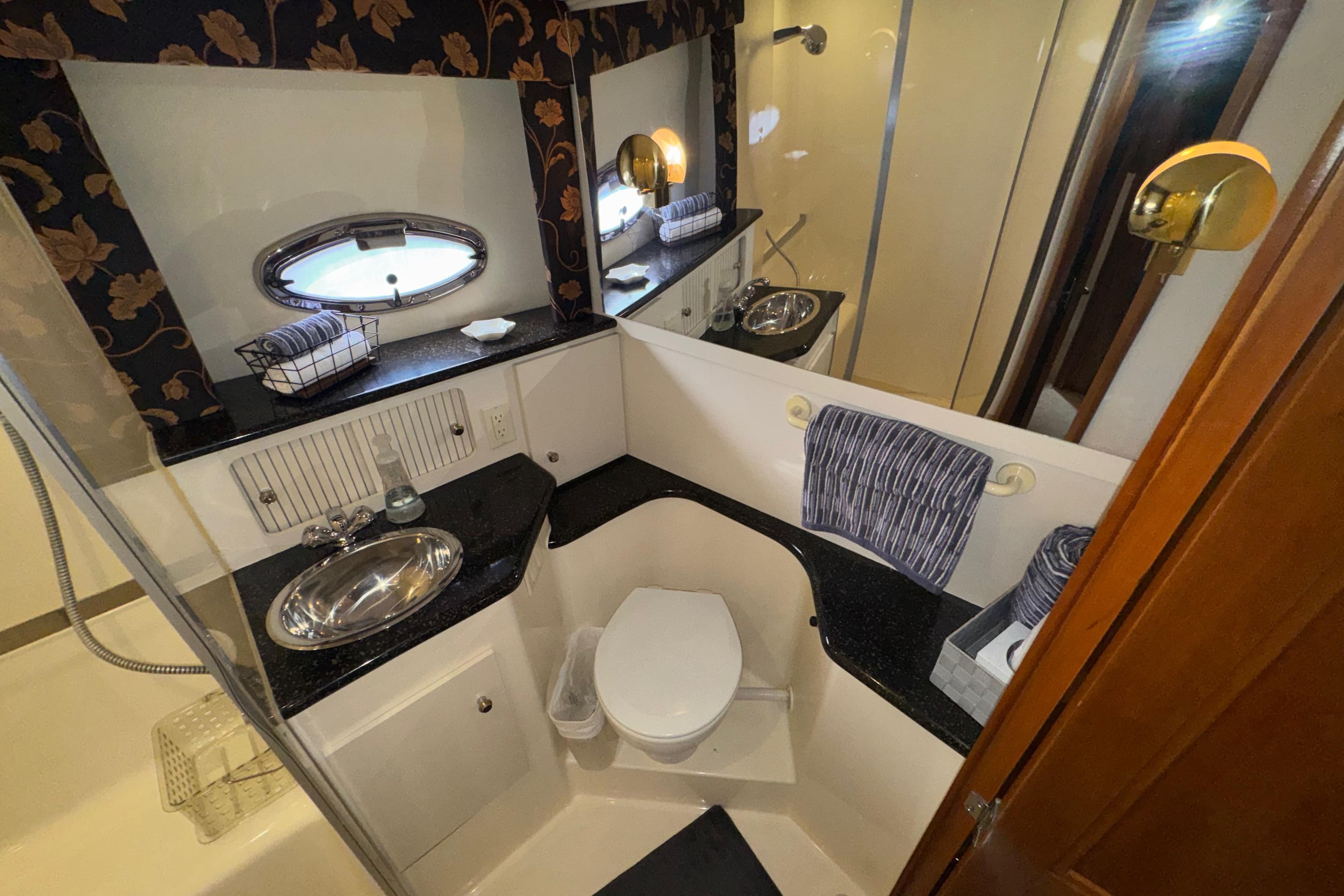 Bathroom interior of 2001 Carver 356 Motor Yacht with sink, toilet, and mirror.