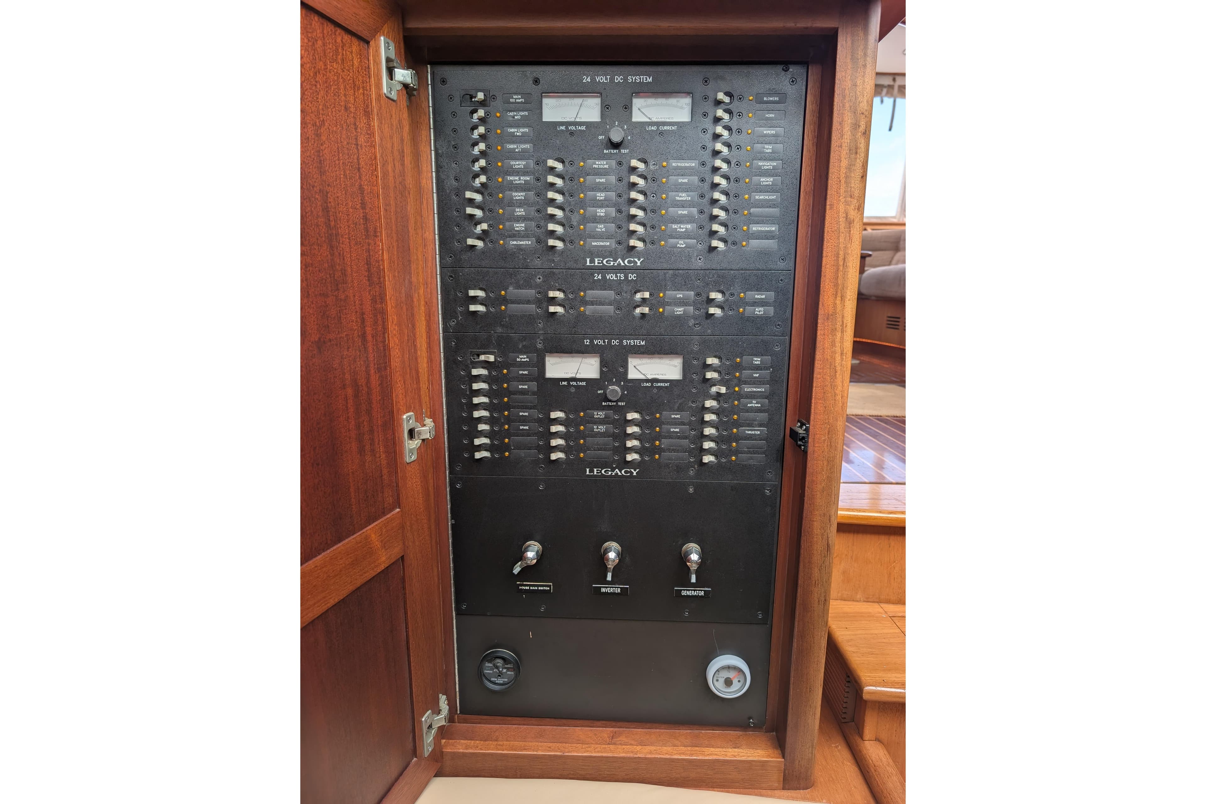 Electrical panel inside 2002 Legacy Yachts 52 Express, featuring switches and controls.