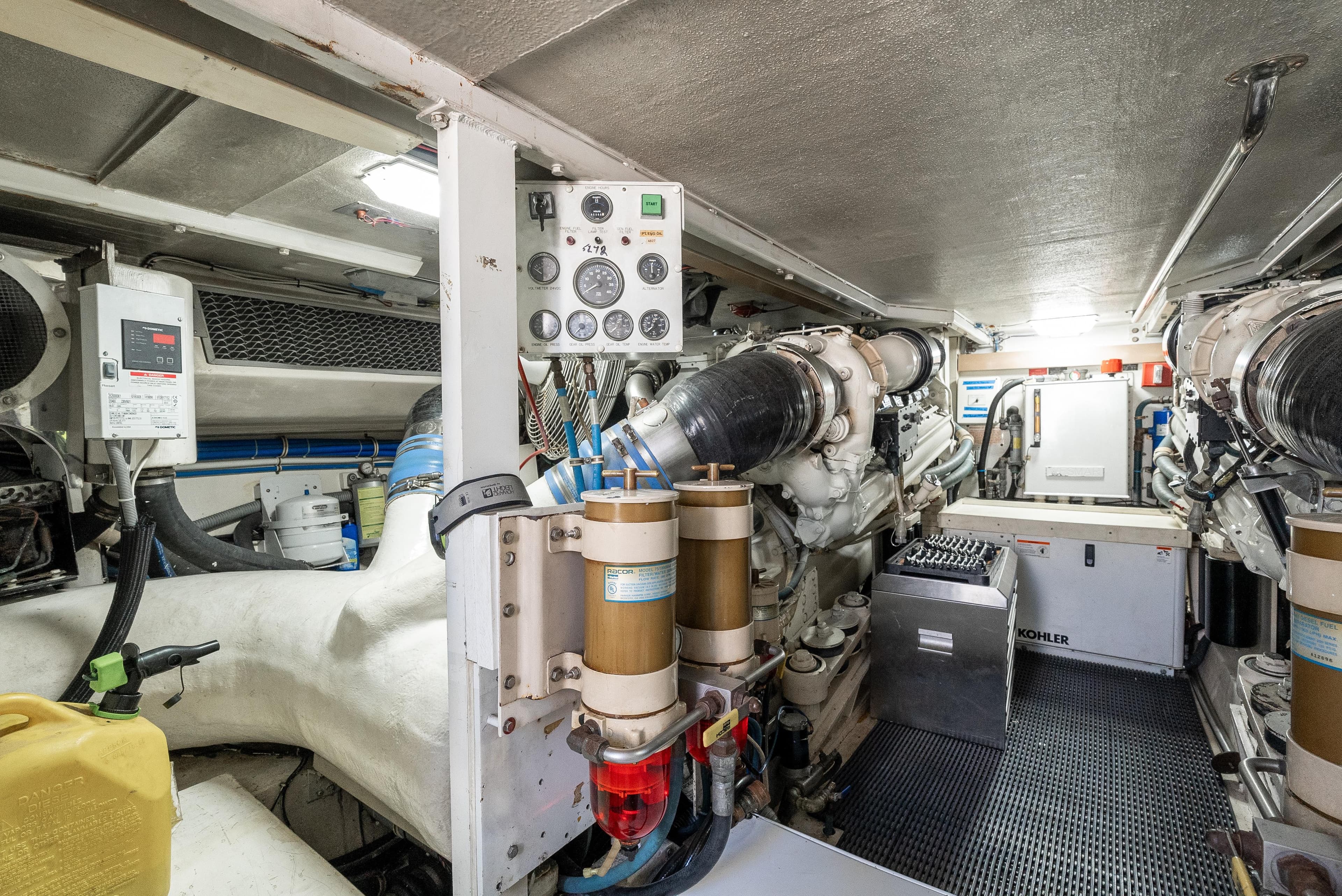 Engine room of 2000 Hatteras 70 Convertible yacht, showcasing machinery and equipment.